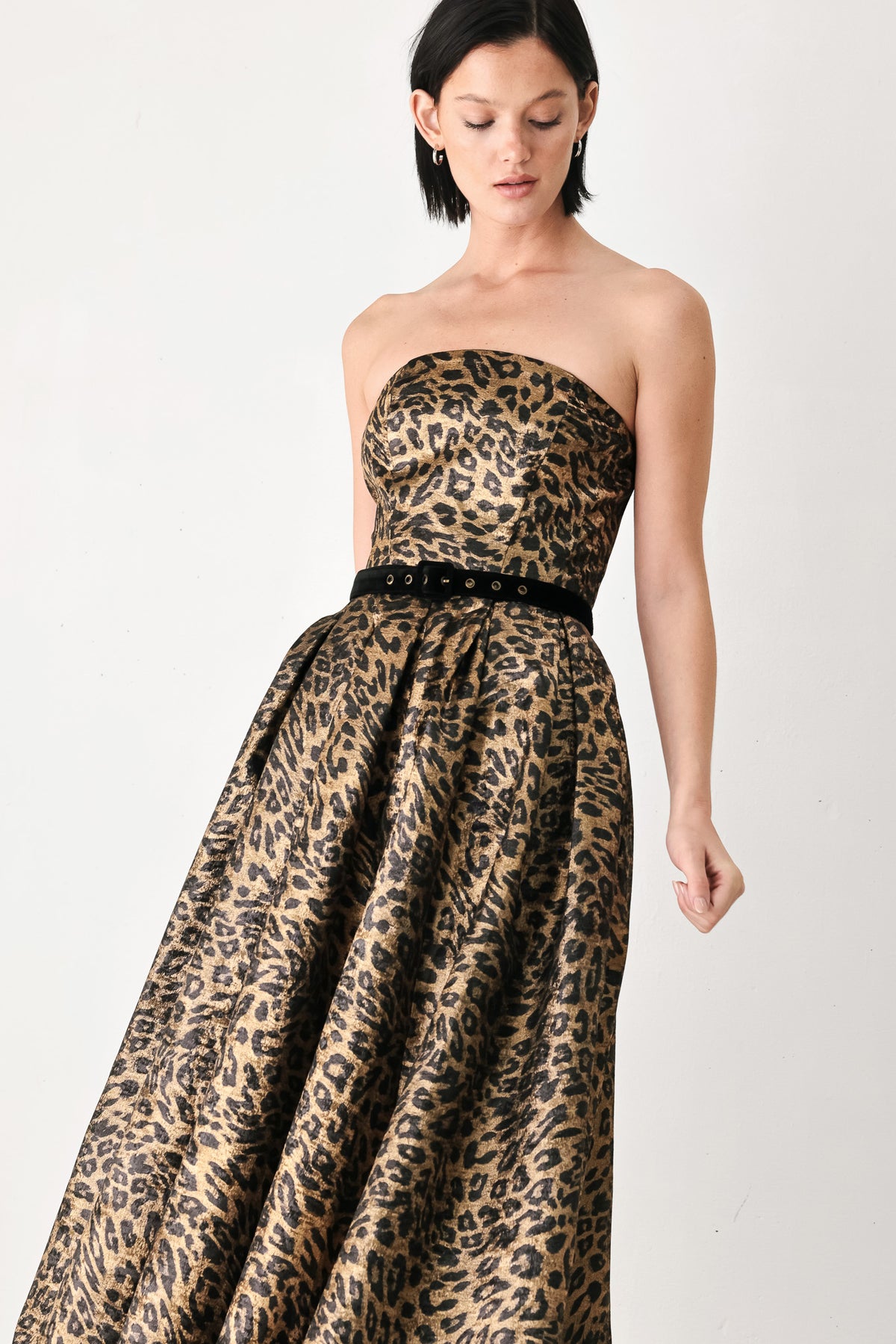 A woman modeling a strapless leopard-print midi dress with a black waist belt | FREEMARKET