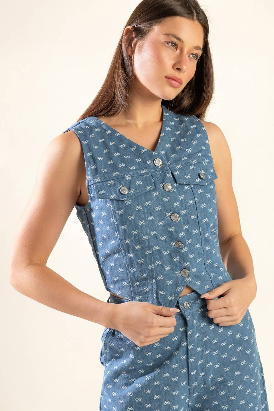 A textured woven vest featuring sleeveless and front button closure.