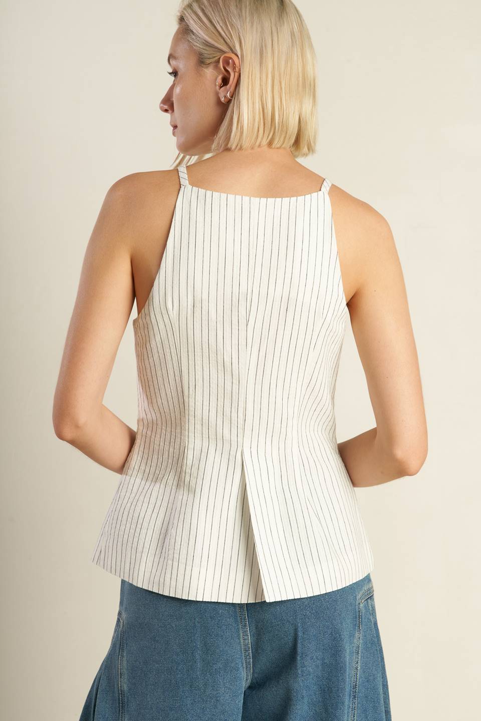 A woven seersucker top featuring sleeveless, button down and faux pocket. Matching pant FP1474