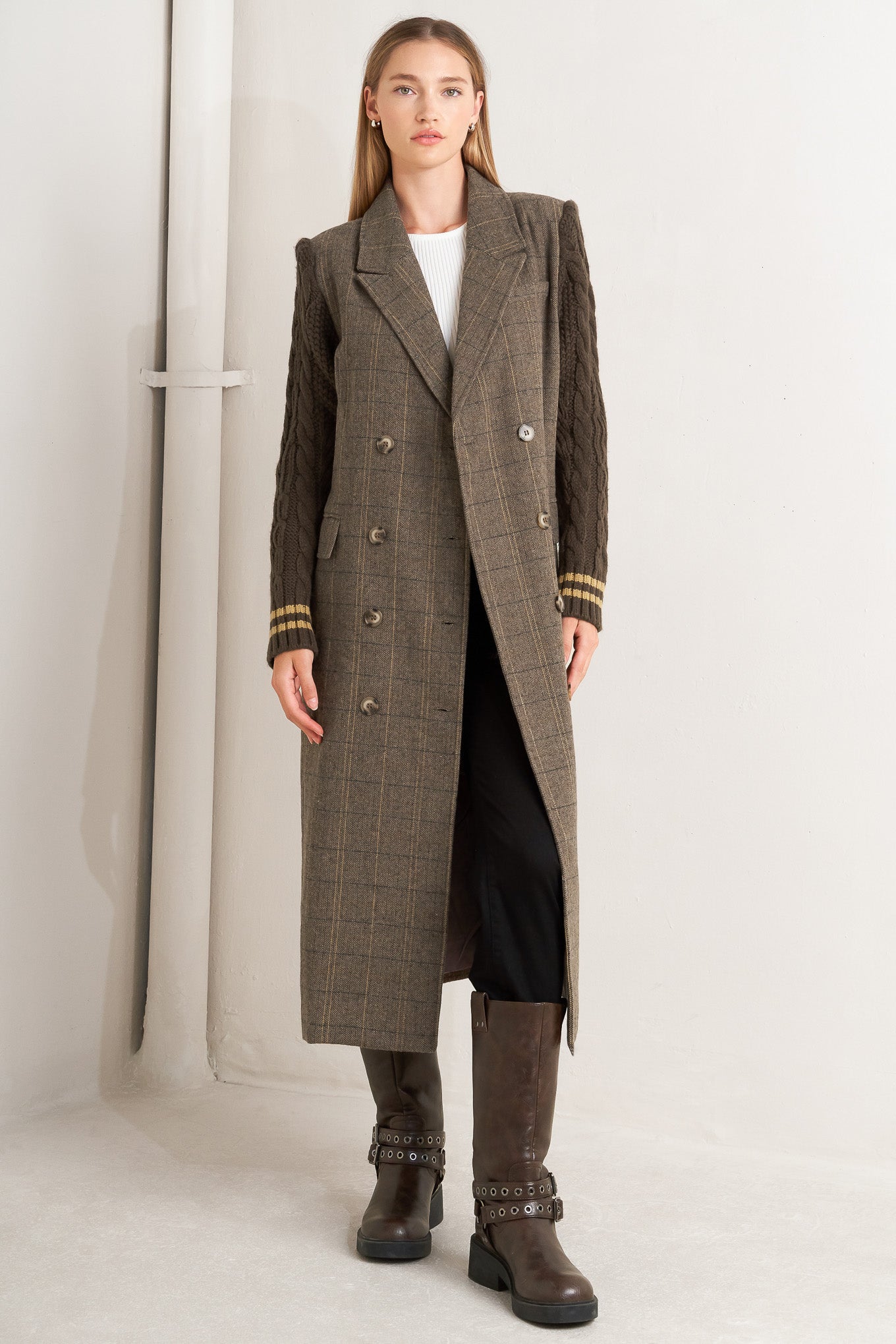 A woven midi coat featuring double breast front button closure, contrasting belt and sweater sleeve