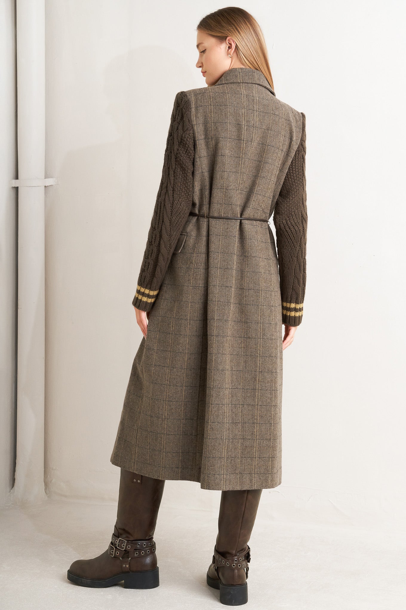 A woven midi coat featuring double breast front button closure, contrasting belt and sweater sleeve