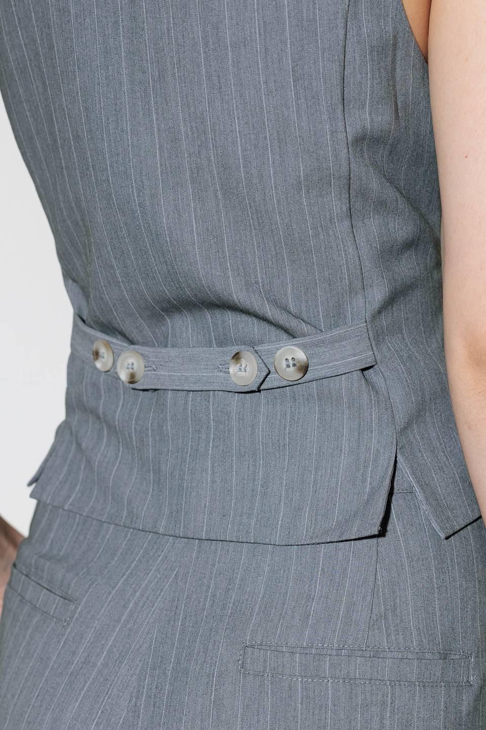 A grey striped woven vest with front button down.