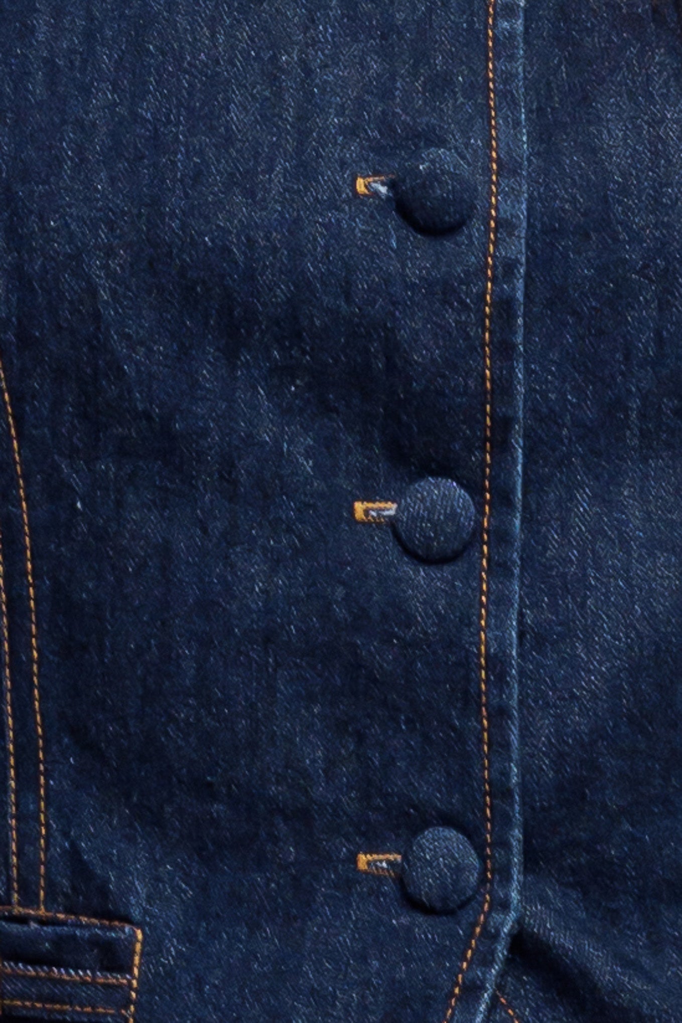 A denim vest featuring round neckline, sleeveless, front button down and hardware trim.