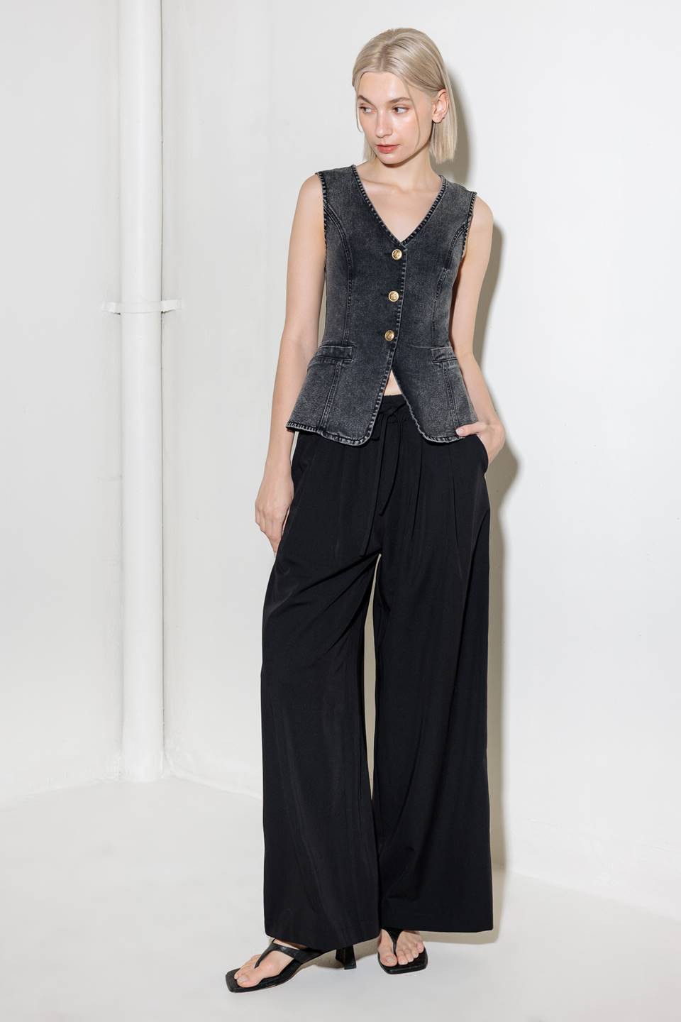 A washed denim vest with V neckline and front closure.