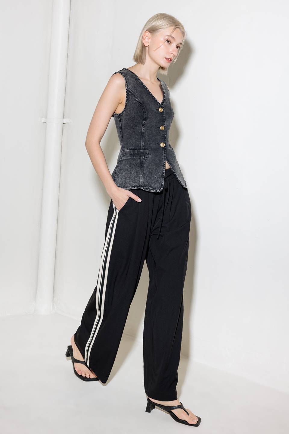 A washed denim vest with V neckline and front closure.