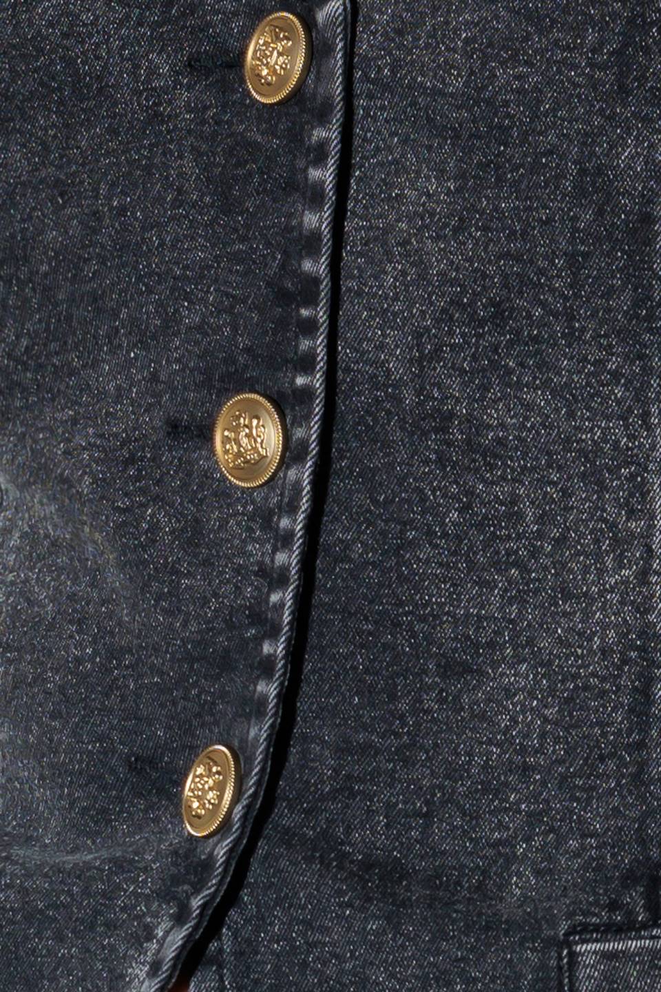 A washed denim vest with V neckline and front closure.
