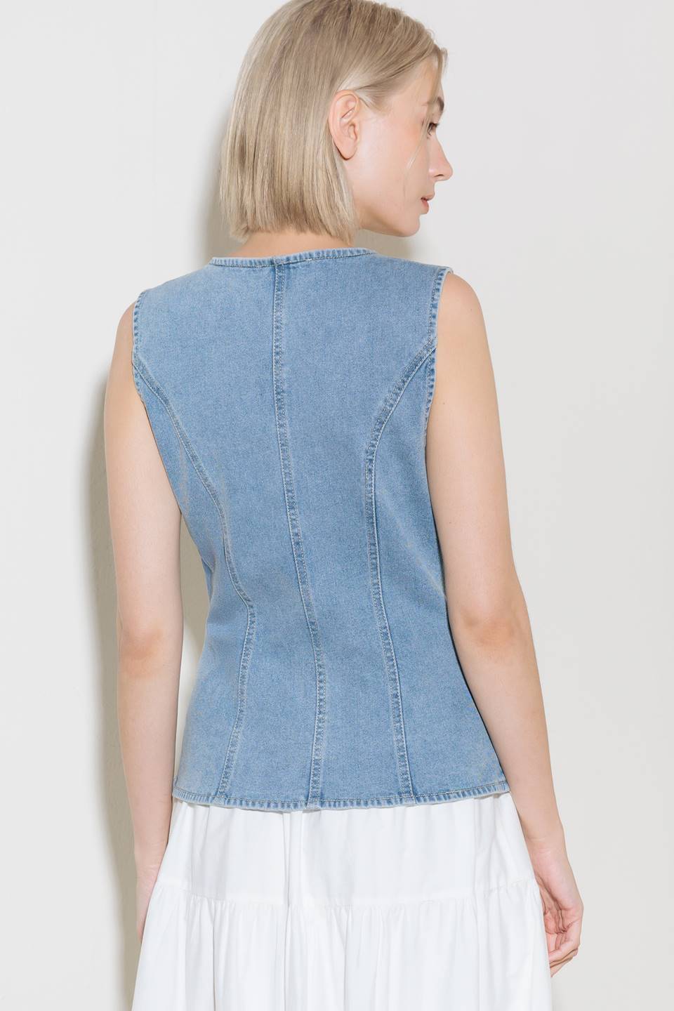A washed denim vest with V neckline and front closure.