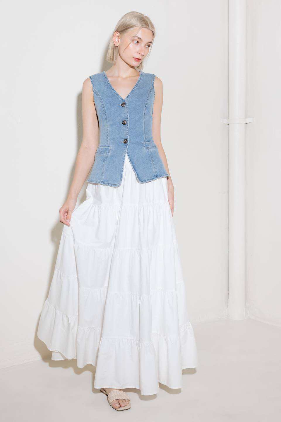 A washed denim vest with V neckline and front closure.