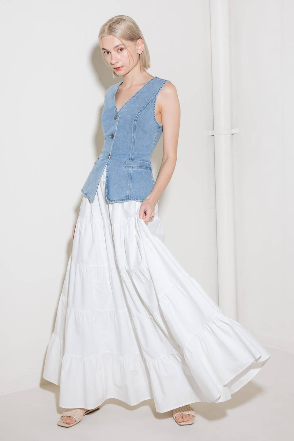 A washed denim vest with V neckline and front closure.