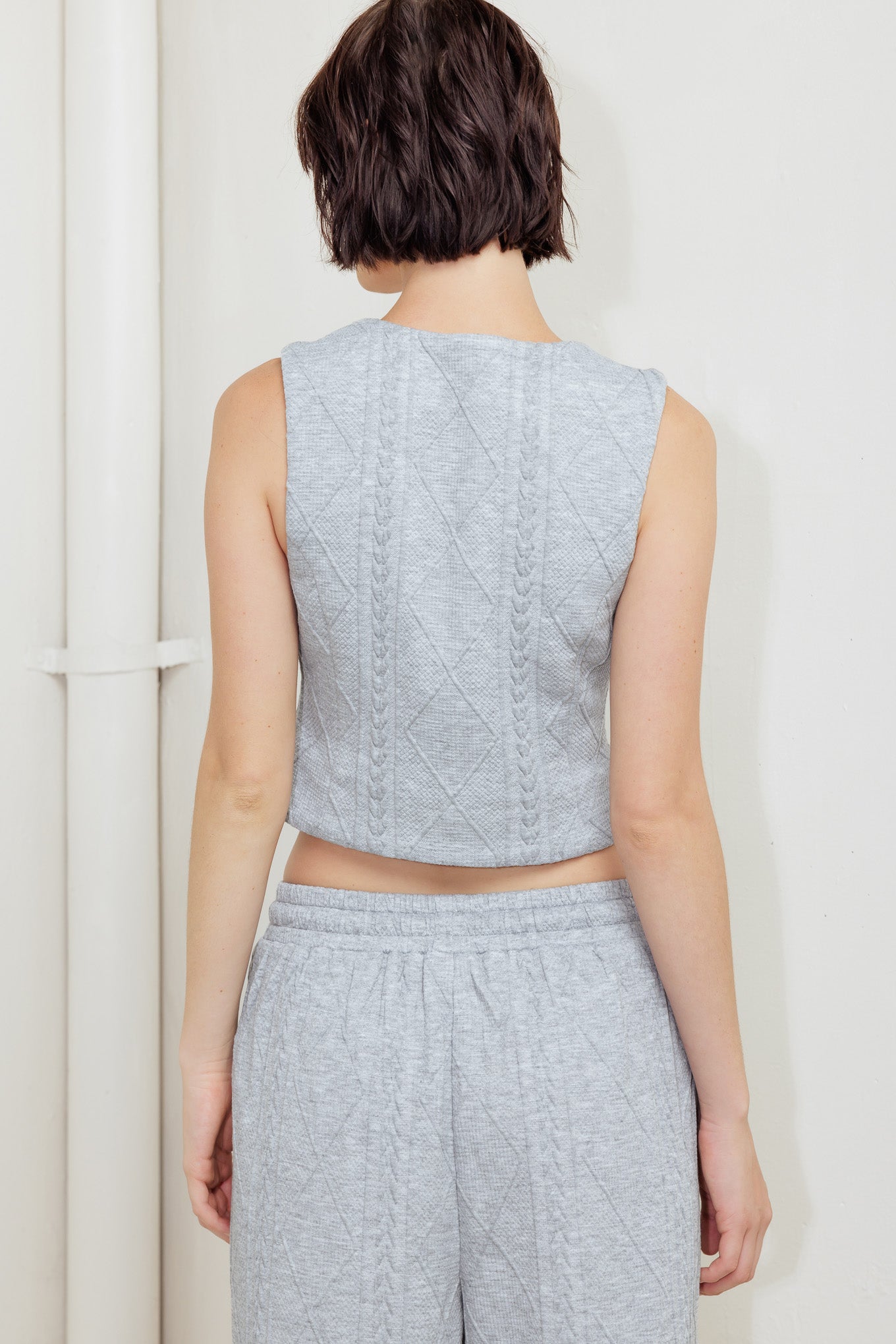 A knit cut/sew vest with front closure.