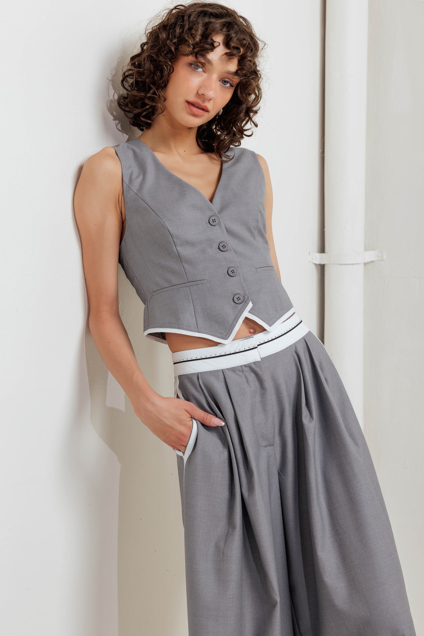 A solid woven vest with front button down closure.