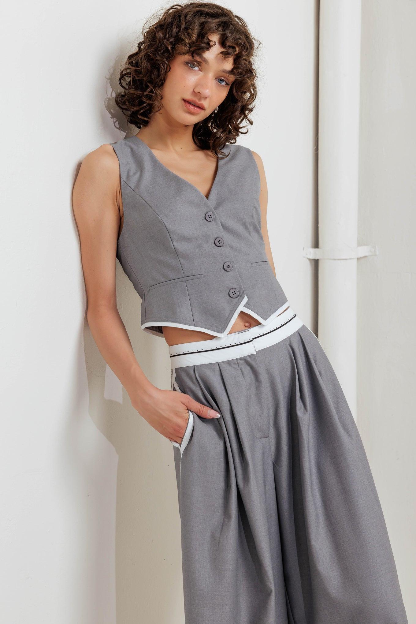 A solid woven vest with front button down closure.