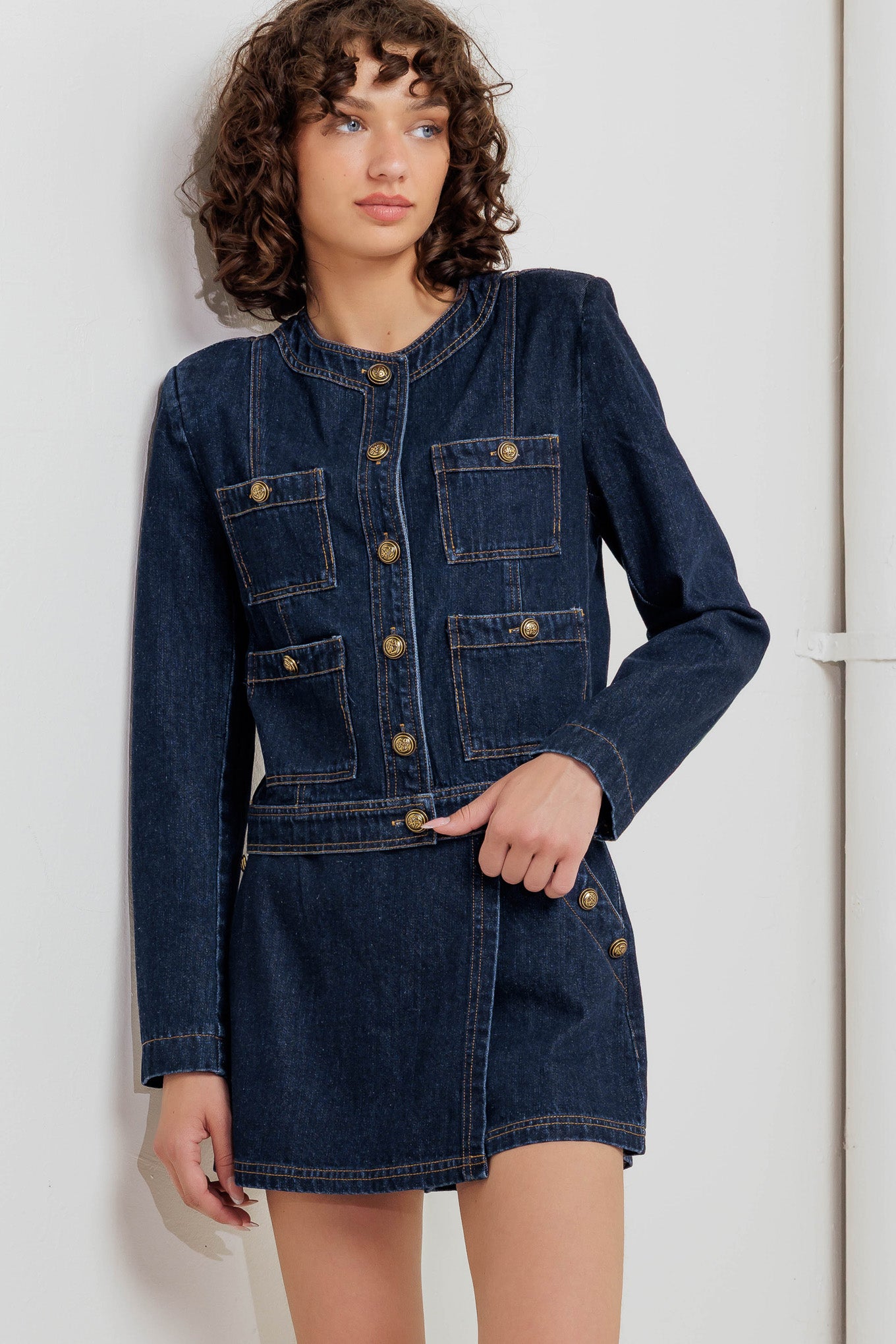 A washed denim jacket with round neck, button down and pockets