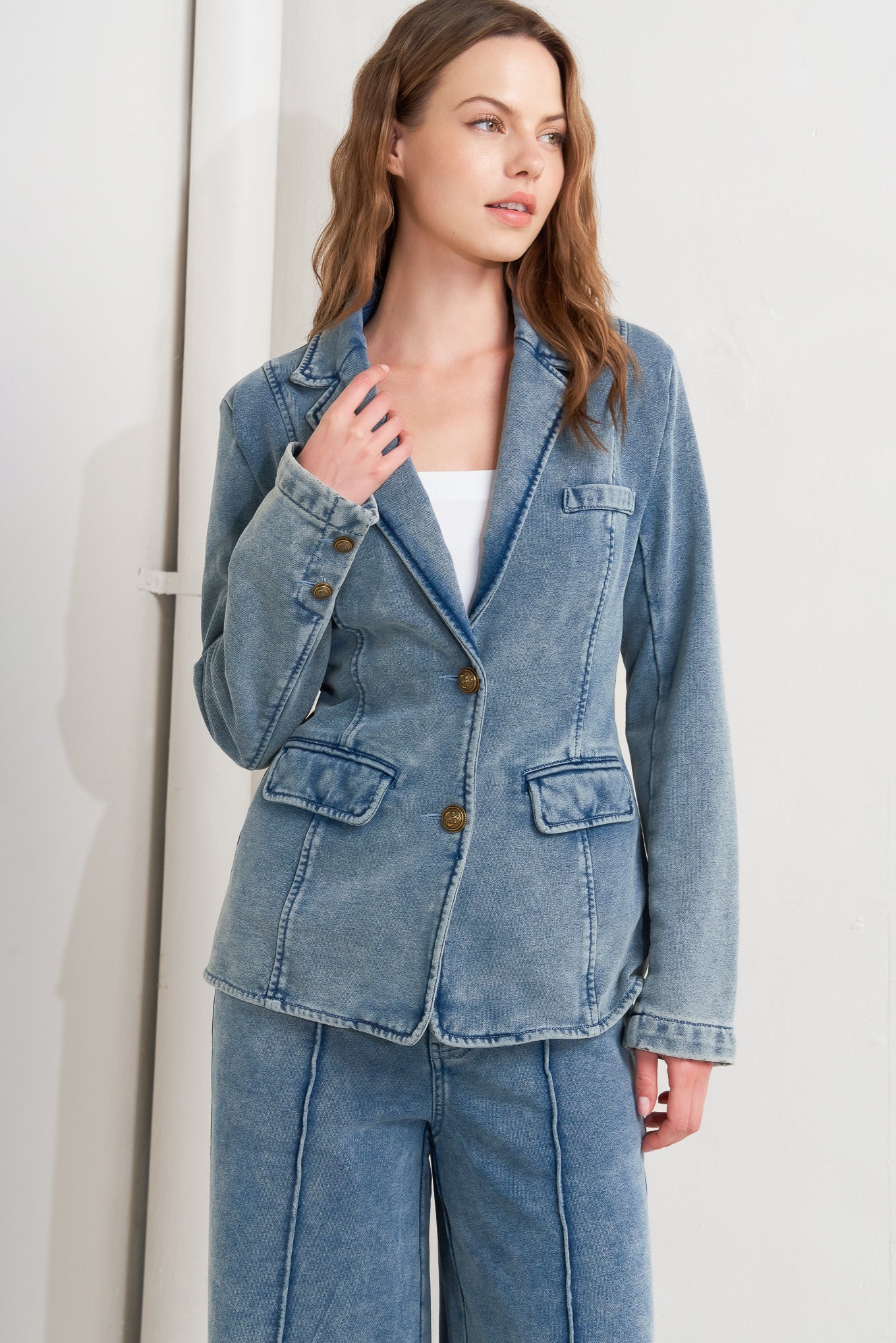 A washed french terry blazer with front button closure and pockets.