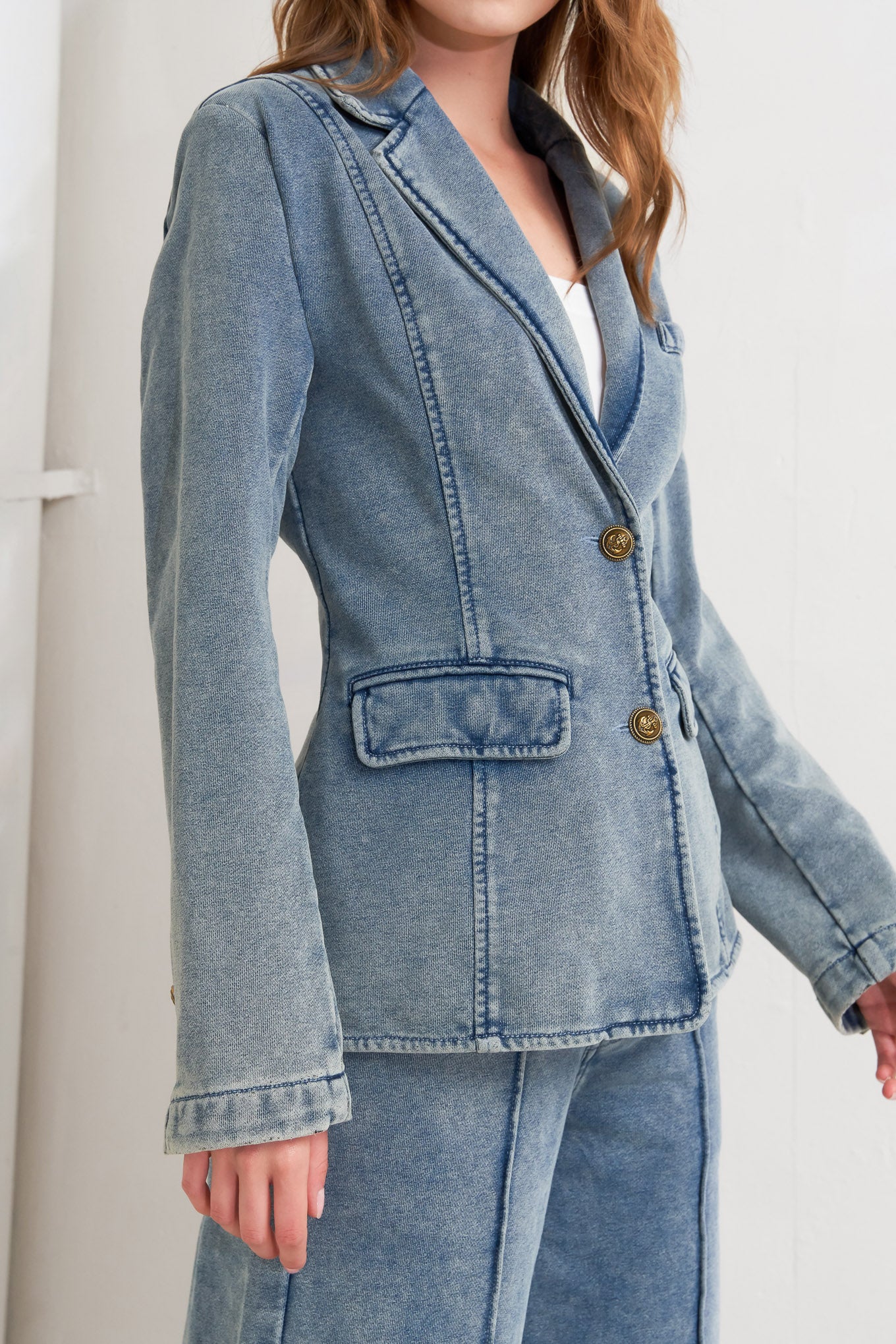 A washed french terry blazer with front button closure and pockets.