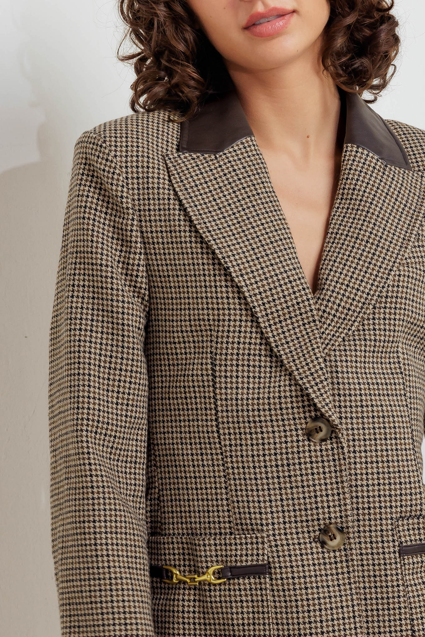 A woven jacket featuring PU contrasting collar, long sleeve, front closure and pockets with trim.