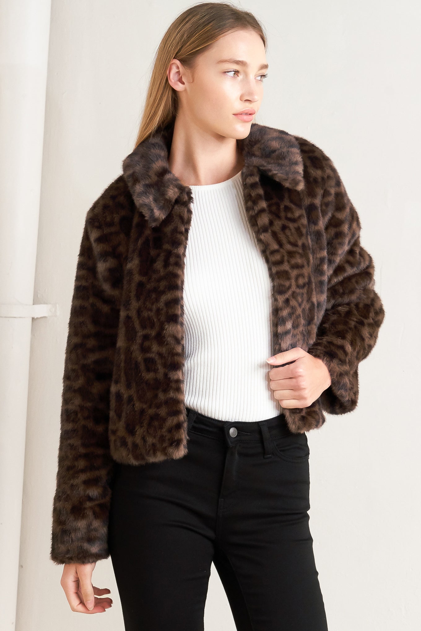 A leopard faux leather jacket with front closure and long sleeve