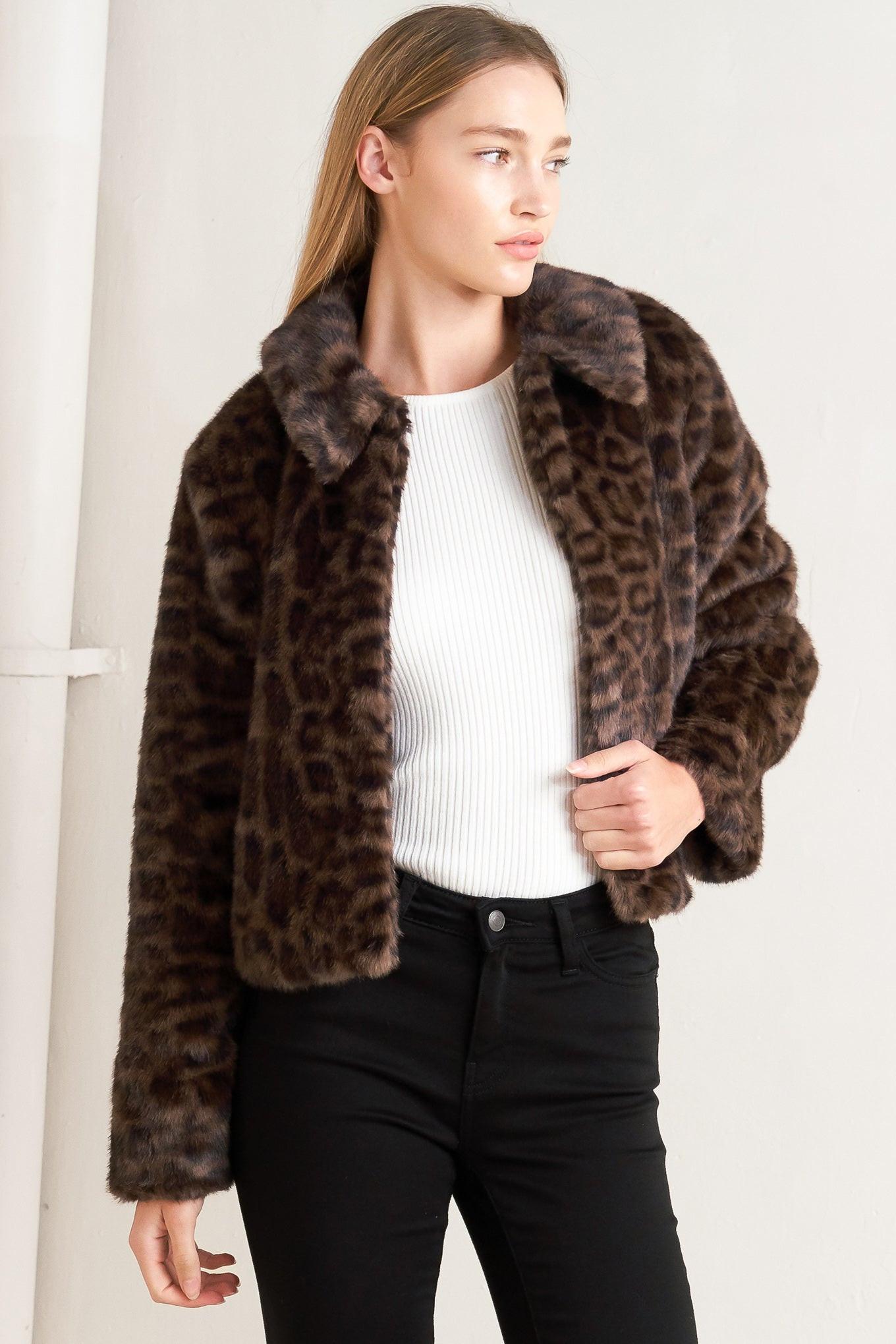 A leopard faux leather jacket with front closure and long sleeve