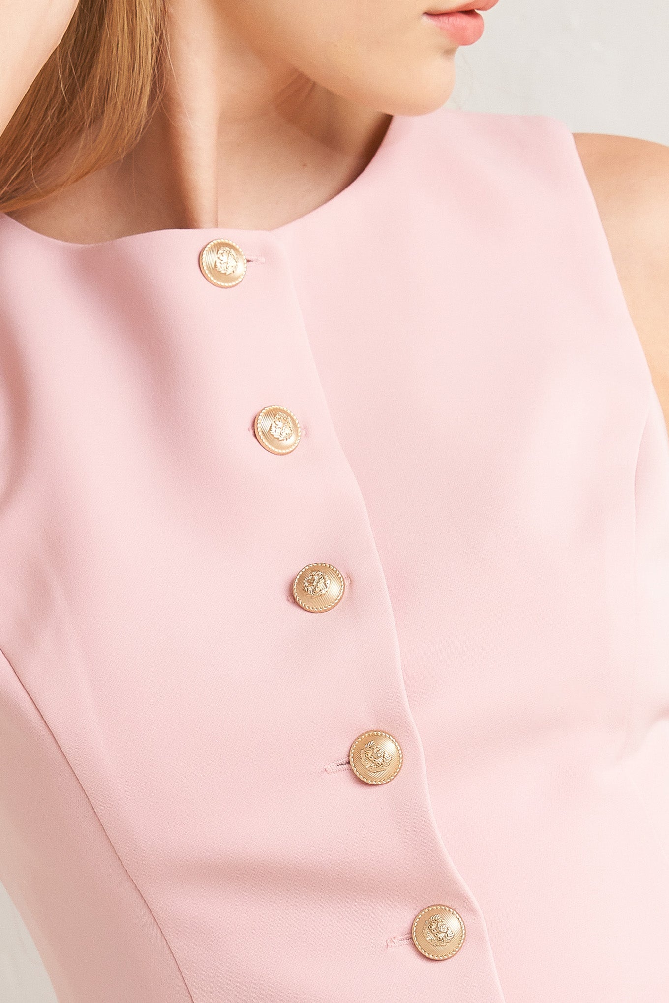 A solid woven vest featuring round neckline, sleeveless and front button down closure.