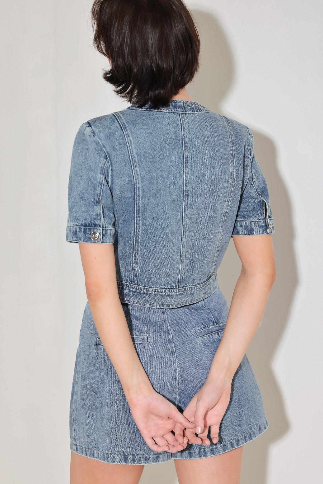 A washed denim jacket featuring round neckline, short sleeve, front pockets and front button down. Matching skort FP2018T
Details:
Self : 100% Cotton
Size & Fit
- Model is 5`8" And Wearing Size Small
- Measurements Taken From Size Small
- Approx. Length: 19"