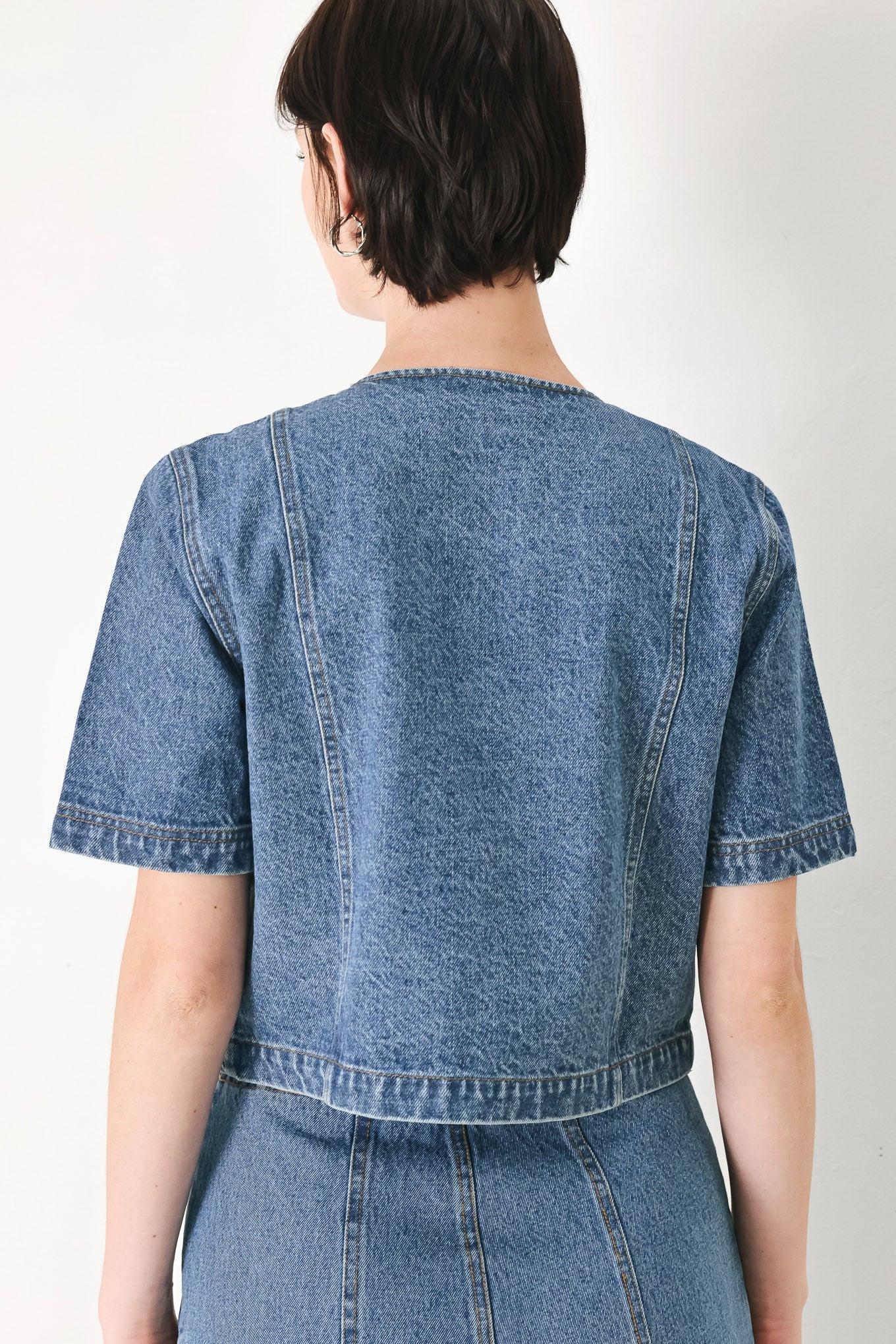 A washed denim jacket featuring round neckline, elbow sleeve, double button down and side pocket.