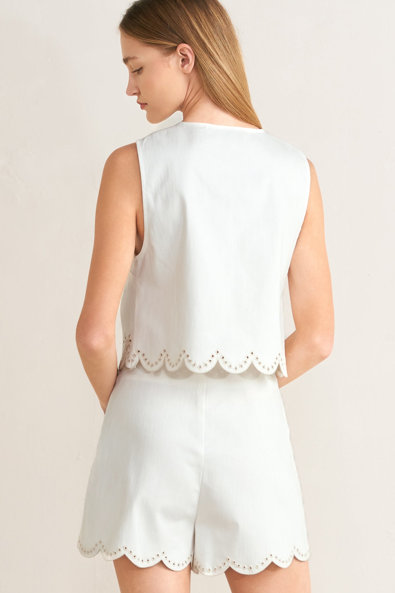 White sleeveless top and shorts set on a plain background