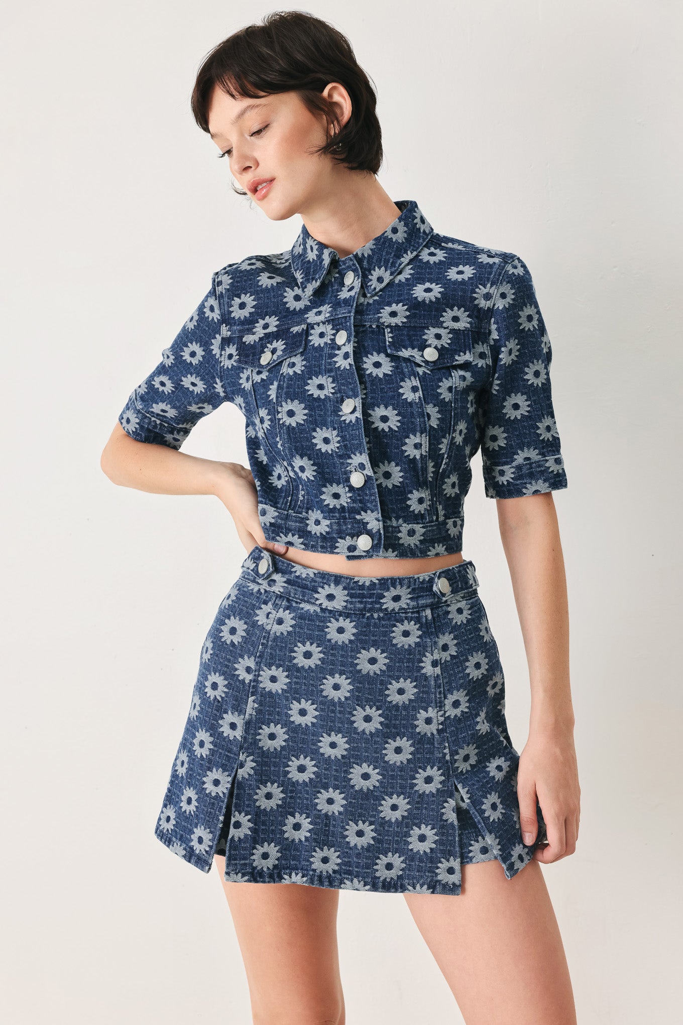 Woman wearing a blue denim floral patterned jacquard crop jacket featuring collar, elbow sleeve and front button closure | FREEMARKET