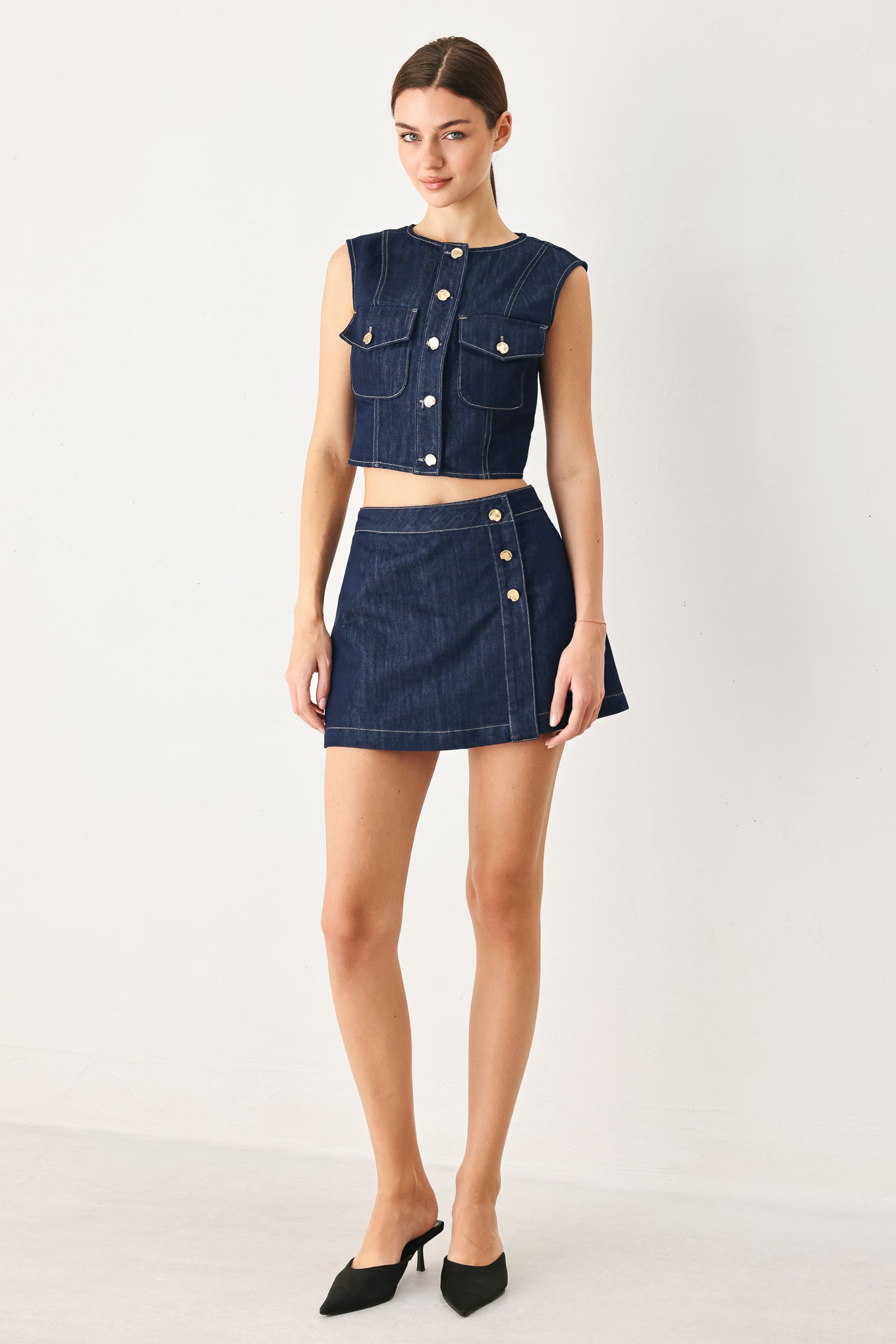 Woman wearing a denim denim crop vest with front button closure | FREEMARKET