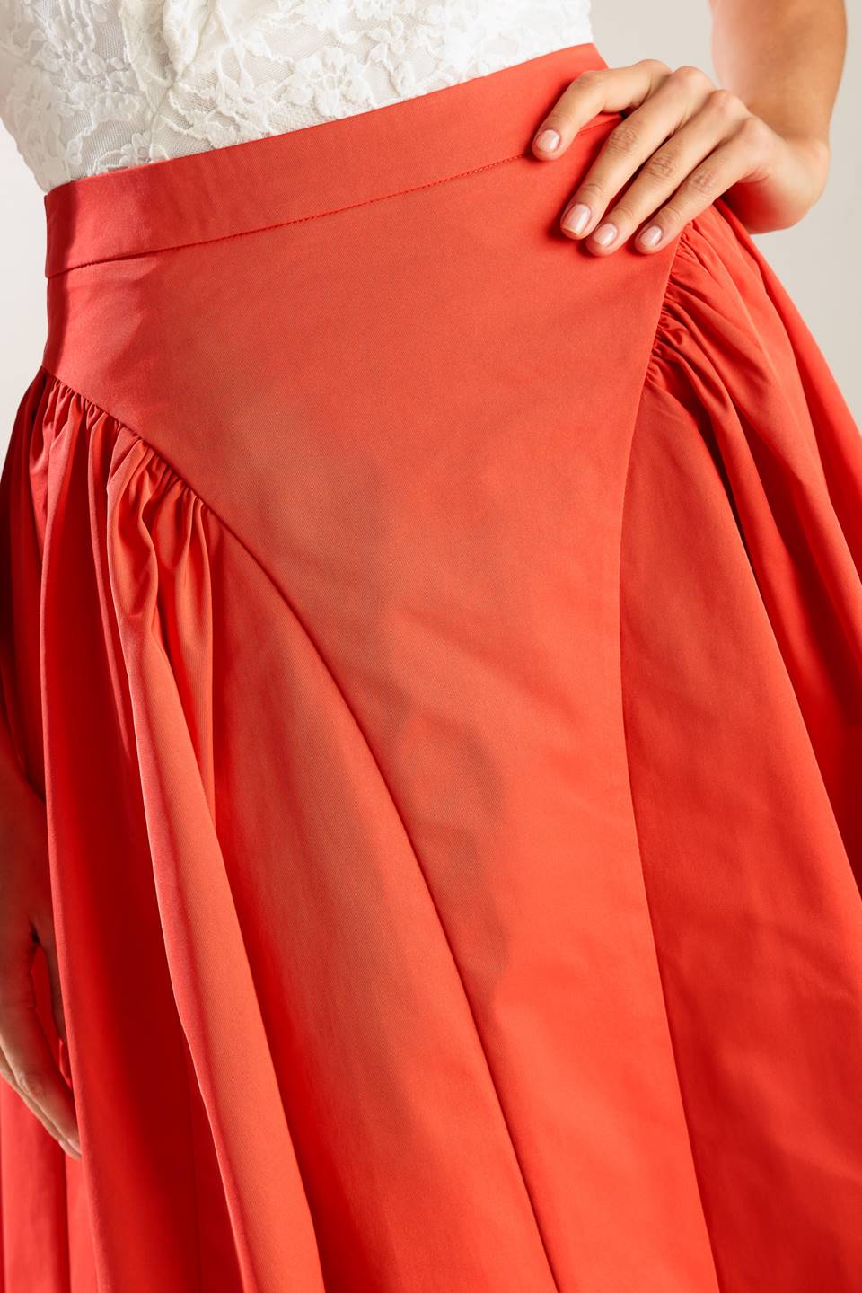 A solid tomato red woven full midi skirt with back zipper closure