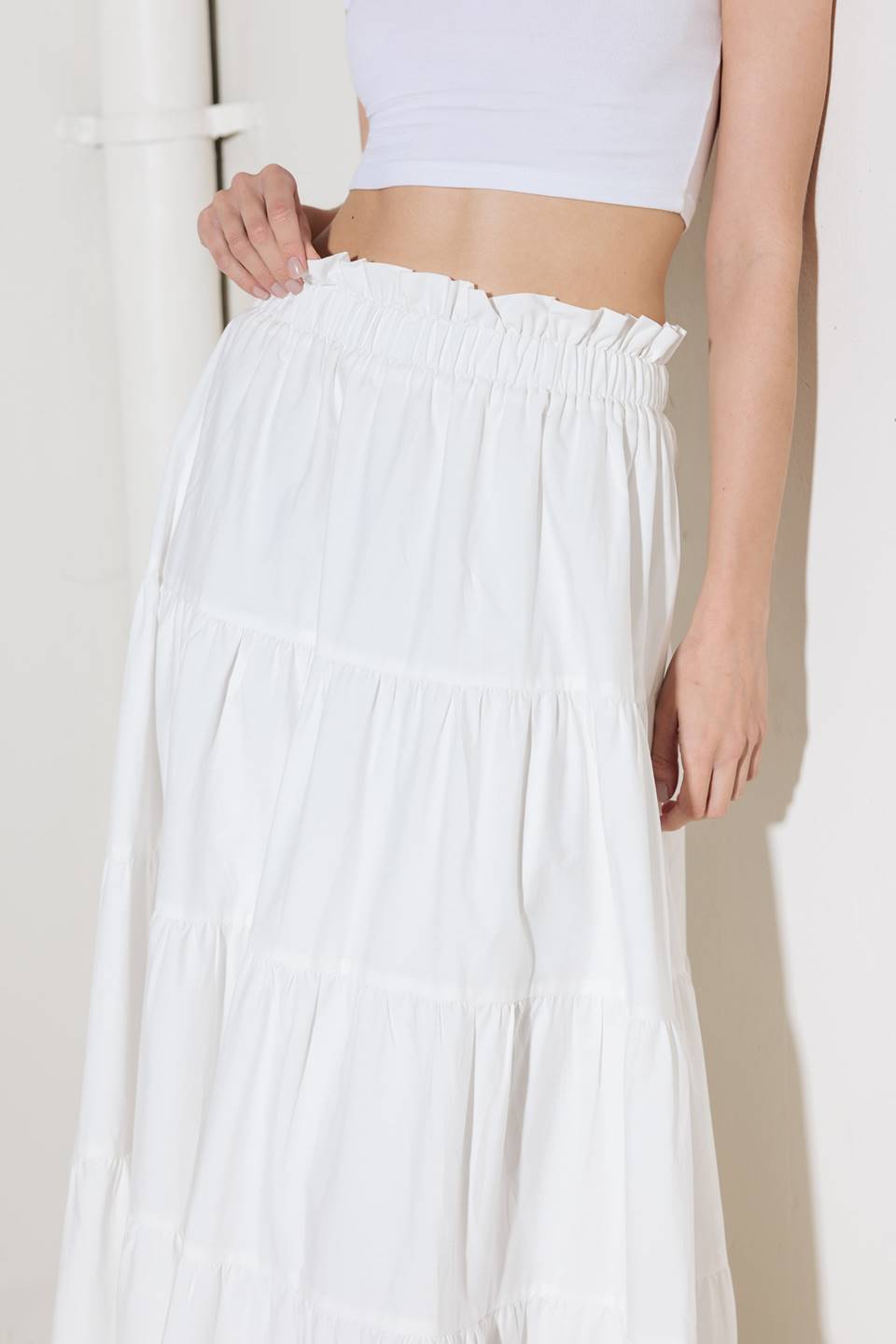 A woven maxi skirt featuring an elasticized waist and tiers.