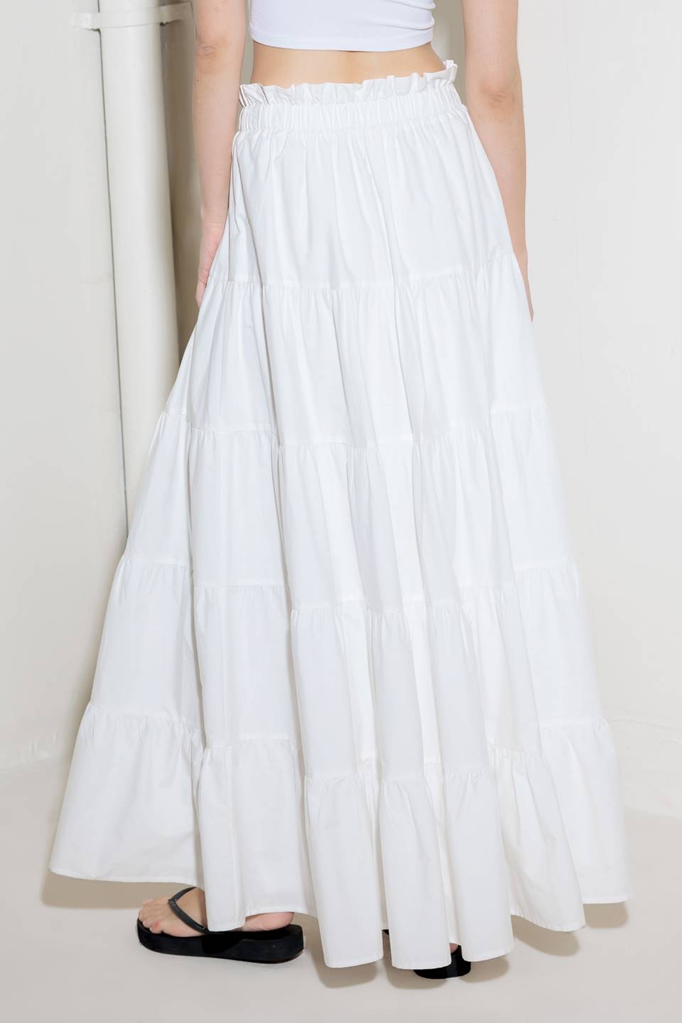 A woven maxi skirt featuring an elasticized waist and tiers.