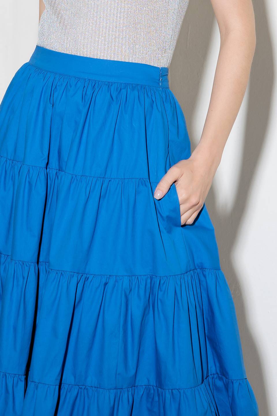 A solid royal blue woven tiered full midi skirt with side zipper closure.