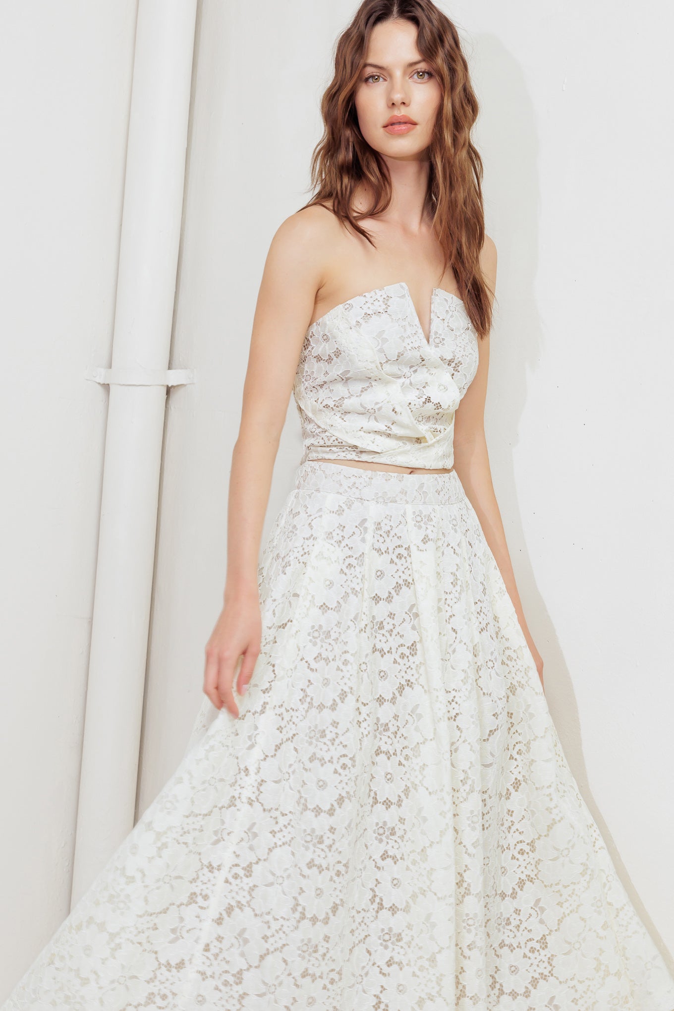 A woven lace midi skirt with back zipper closure.