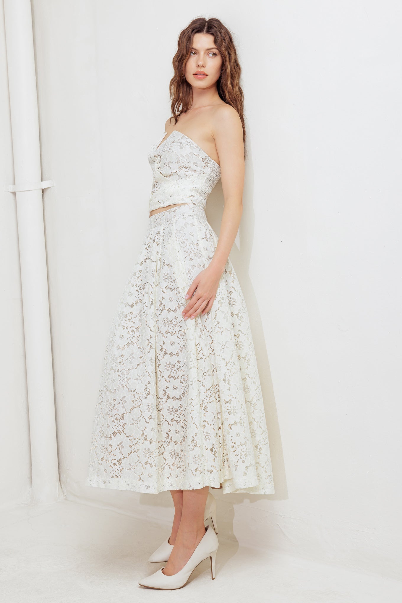 A woven lace midi skirt with back zipper closure.