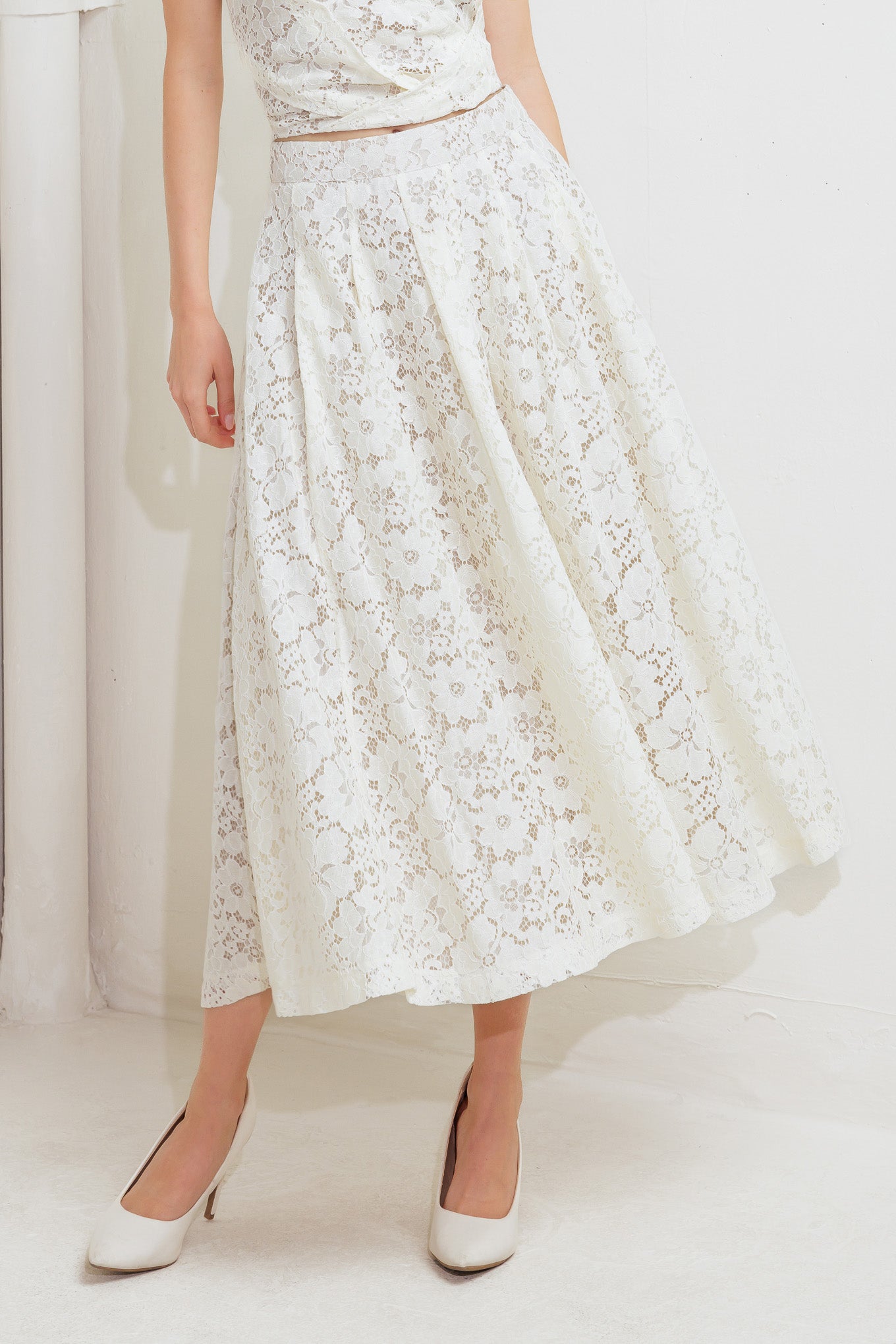 A woven lace midi skirt with back zipper closure.