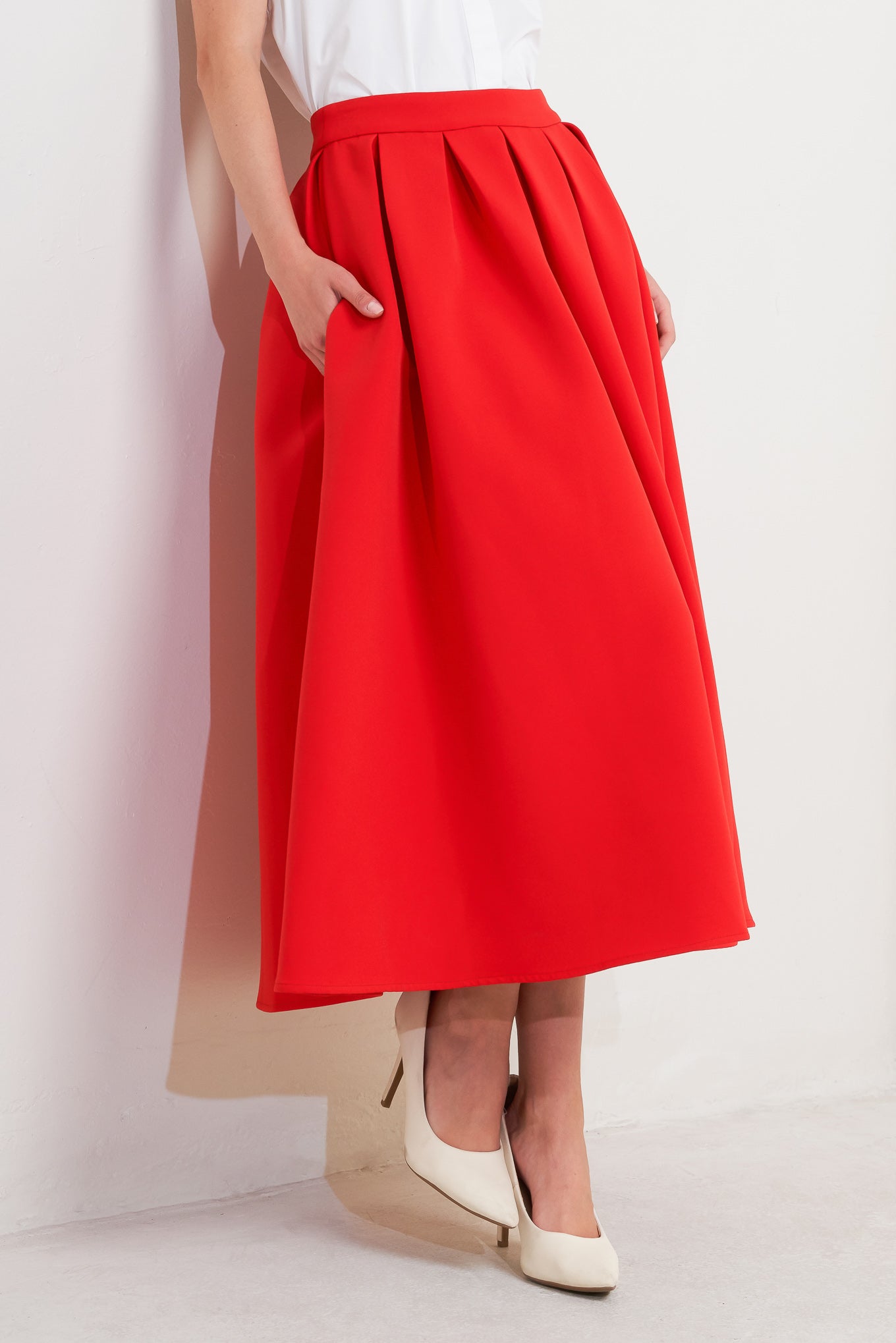 A solid red woven full midi skirt with back zipper closure