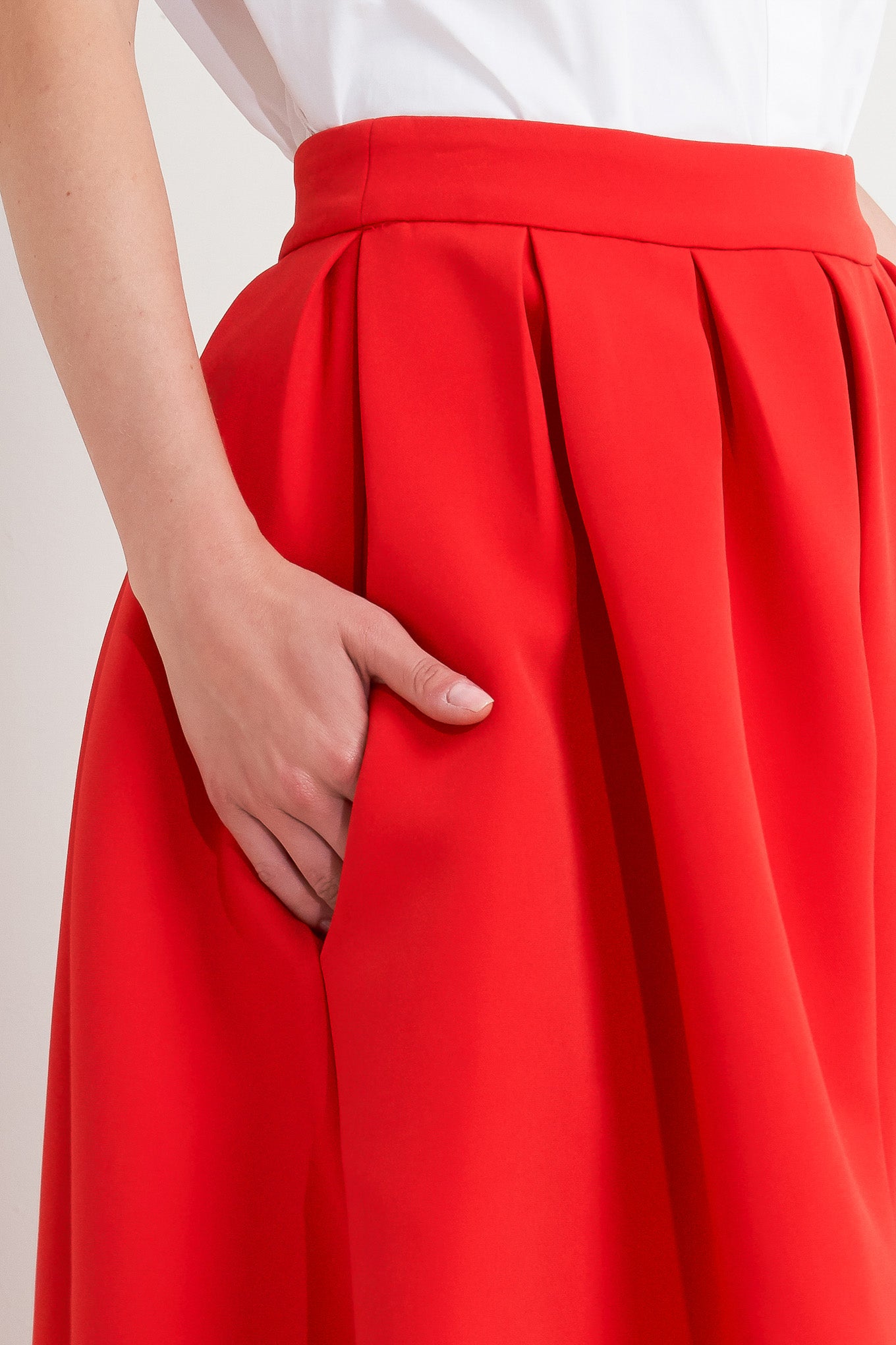 A solid red woven full midi skirt with back zipper closure