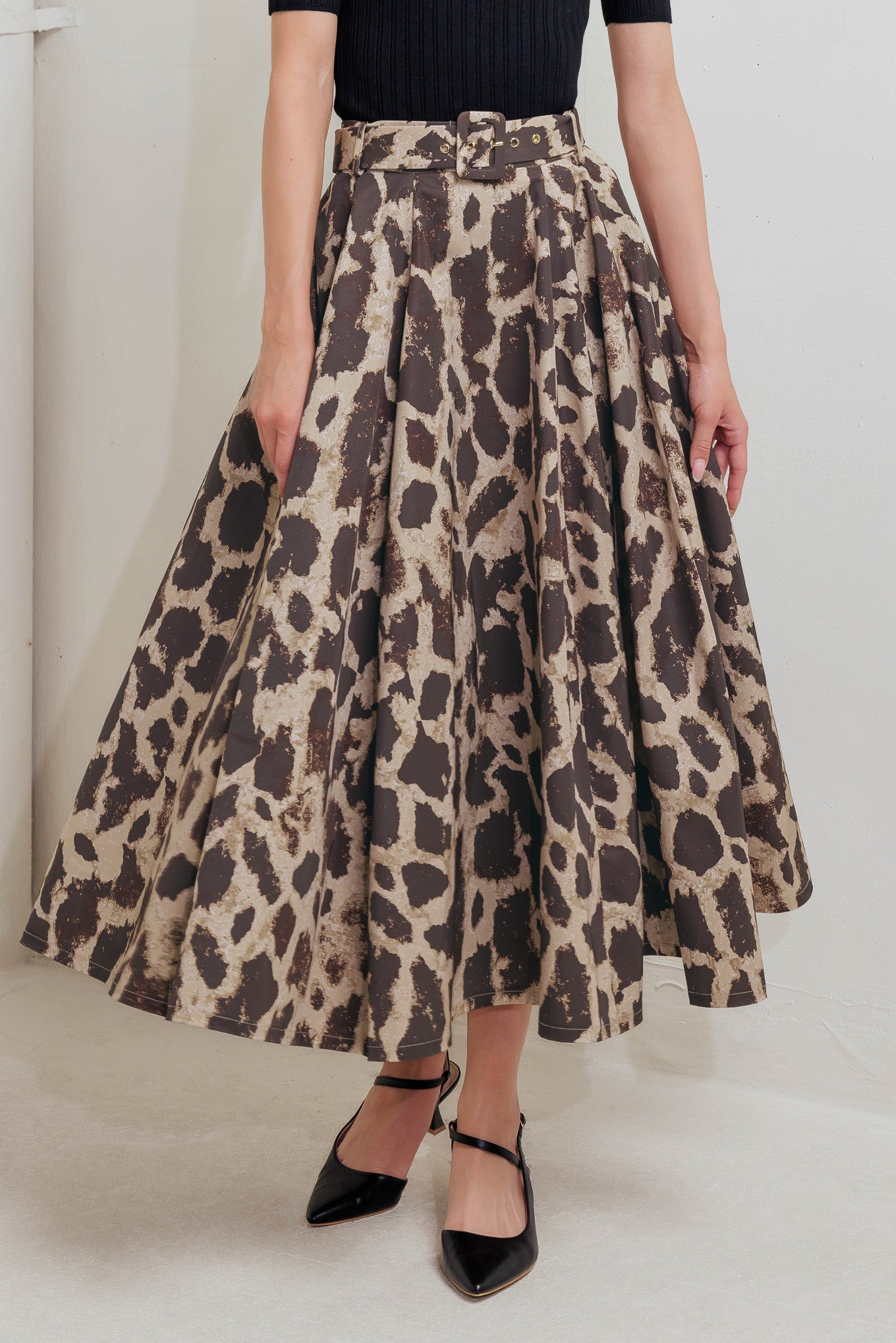 A printed woven full midi skirt featuring self belt, side pockets and zipper closure