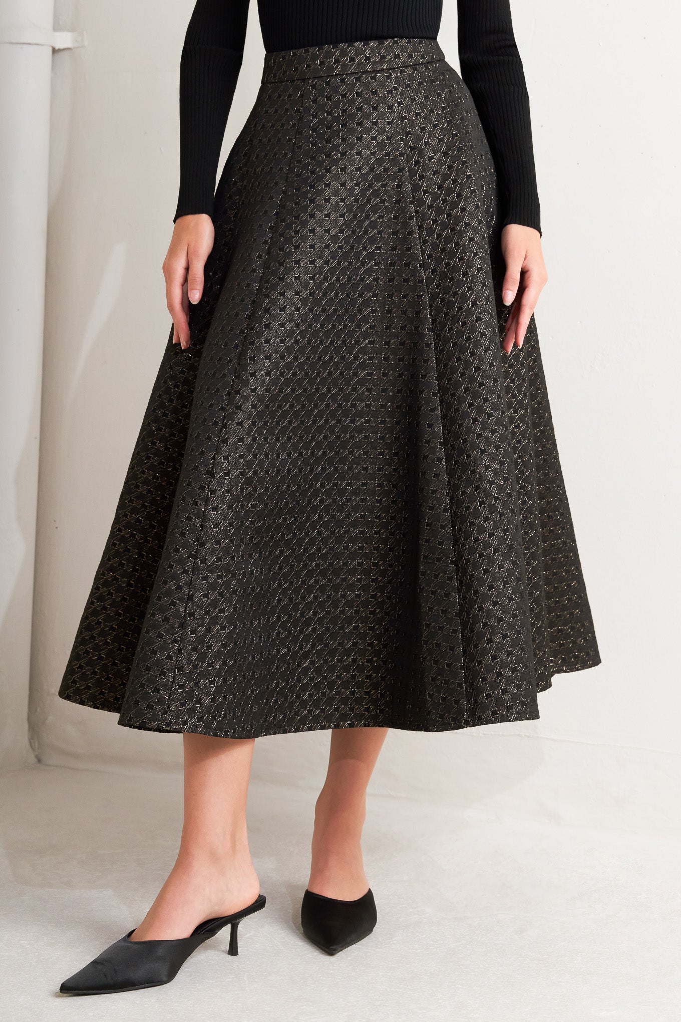 A textured metallic threaded woven circle skirt with back zipper closure.