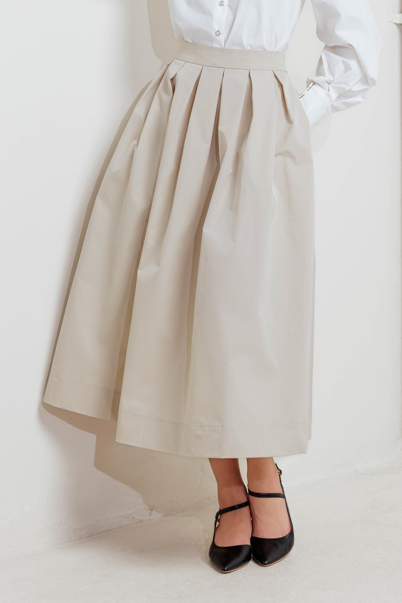 A solid woven full midi skirt with back zipper closure