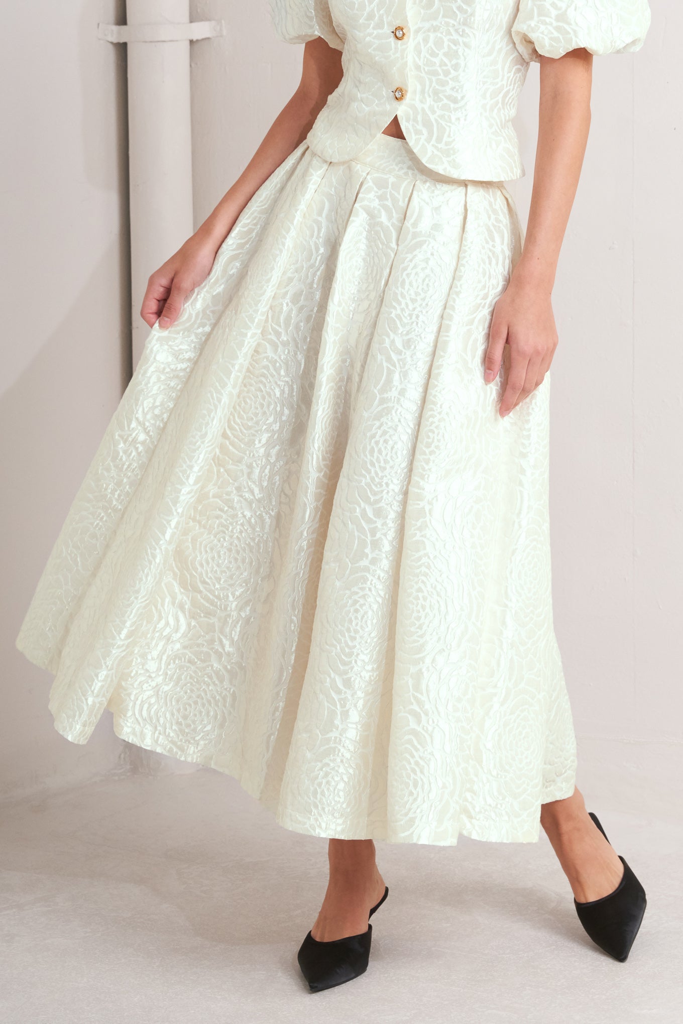 A textured woven full midi skirt with back zipper closure.