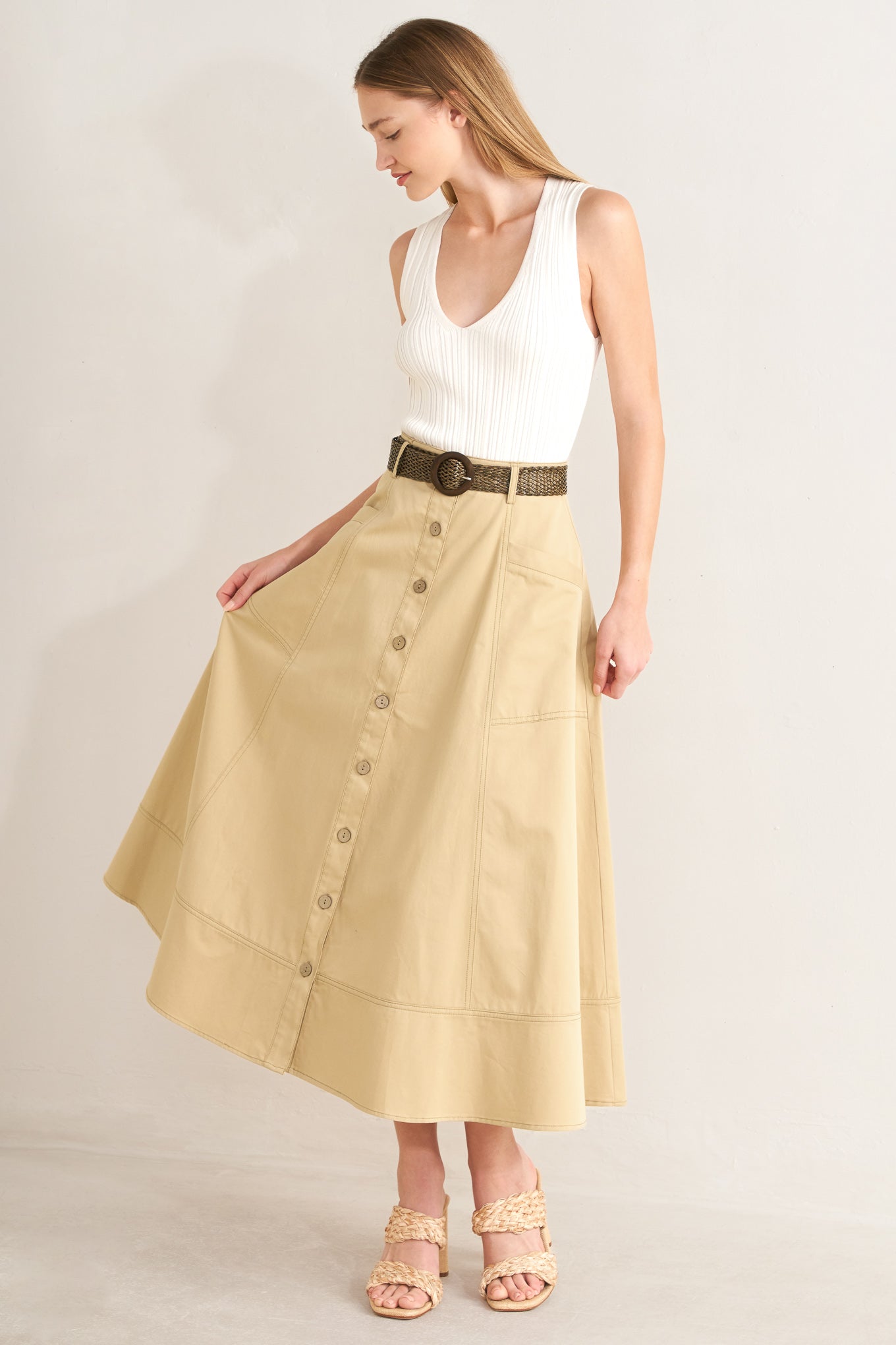 A solid woven midi skirt with front button down and contrasting belt