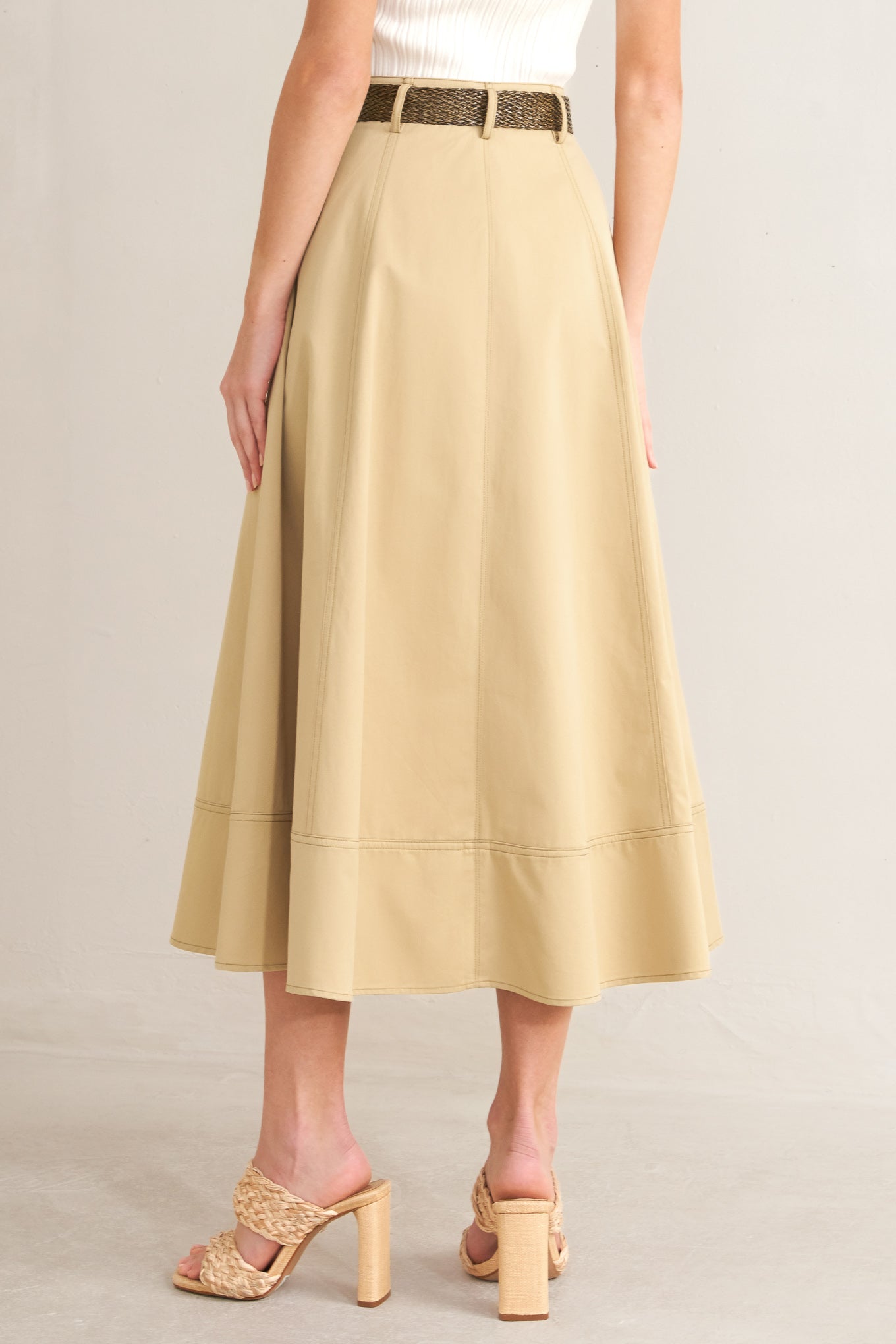 A solid woven midi skirt with front button down and contrasting belt