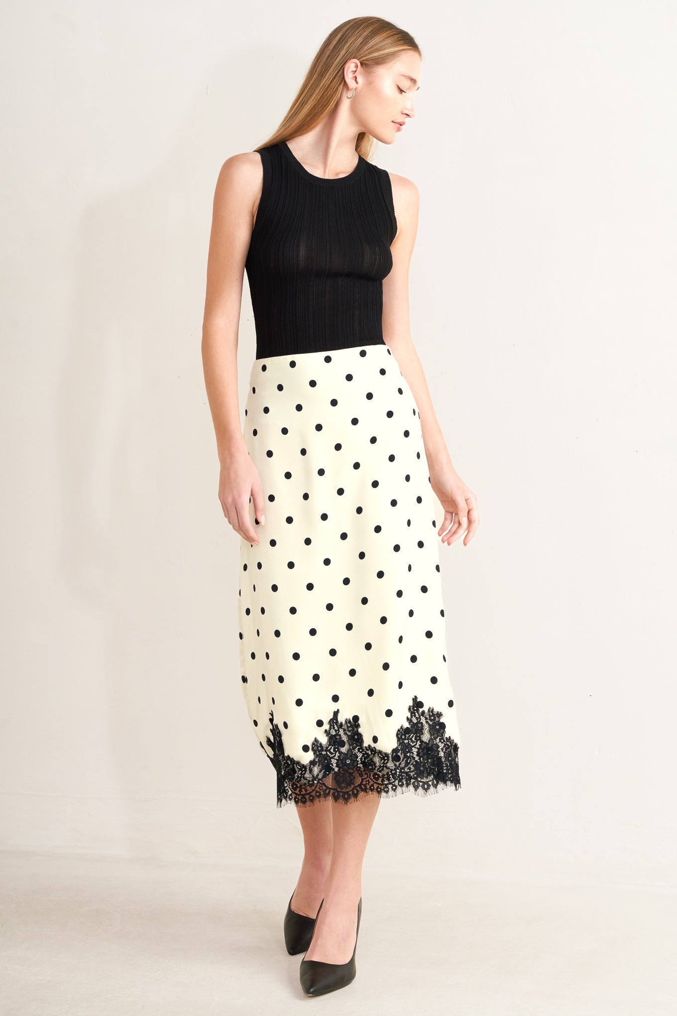 A printed woven midi pencil skirt with lace trimmed hem, back slit and zipper closure
