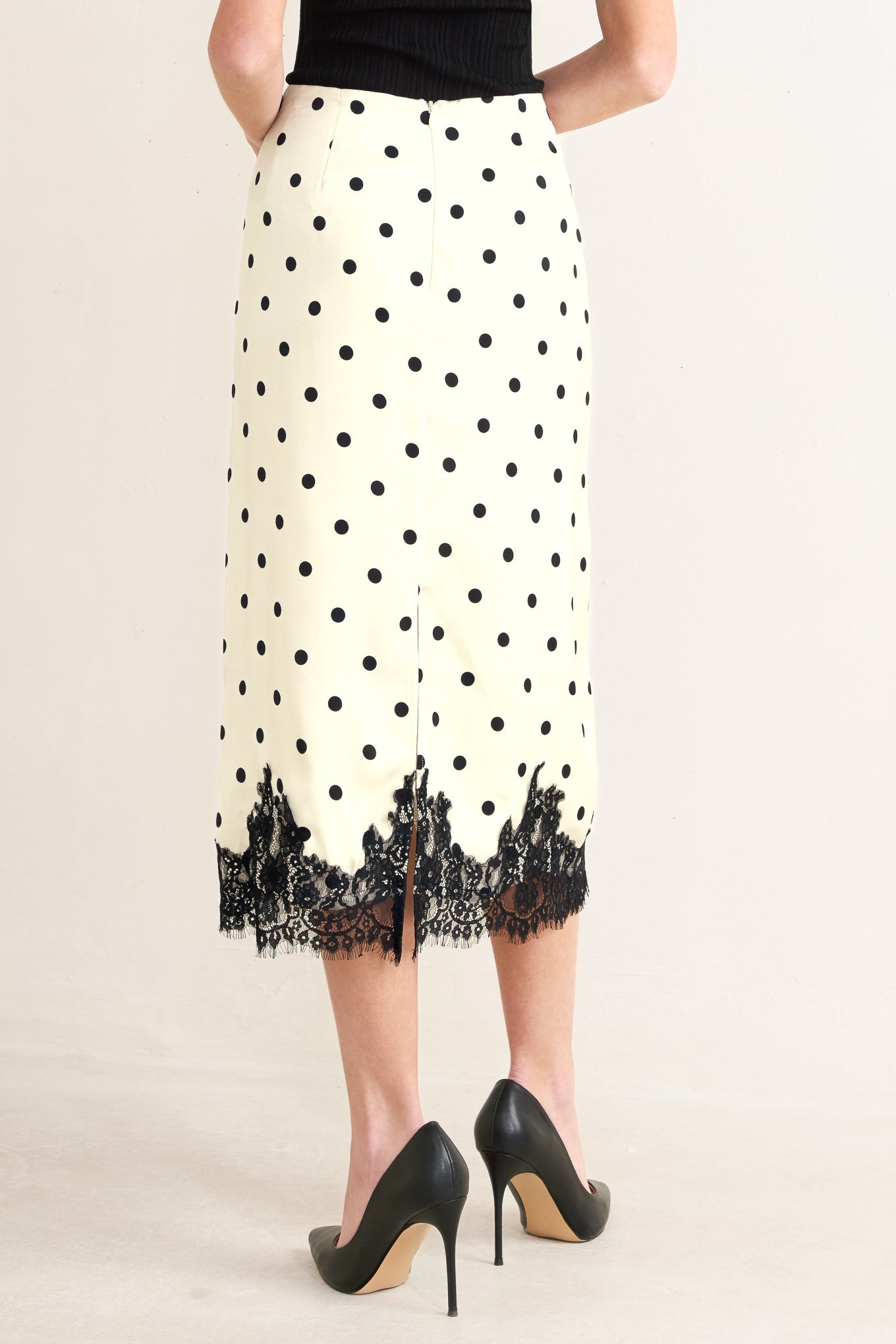 A printed woven midi pencil skirt with lace trimmed hem, back slit and zipper closure