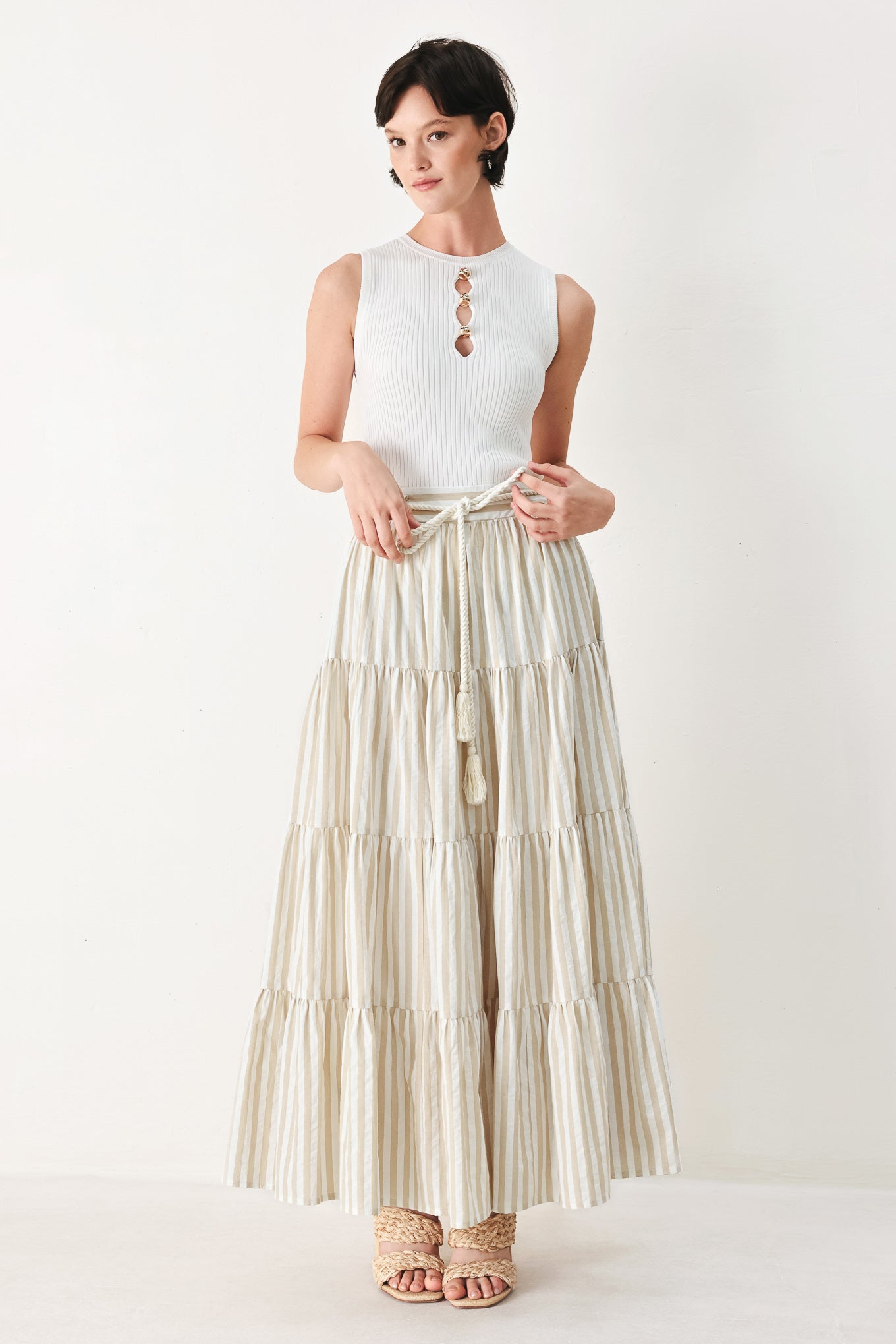 Woman wearing a long, tiered taupe and white striped maxi skirt with rope belt and elastic back waistband | FREEMARKET