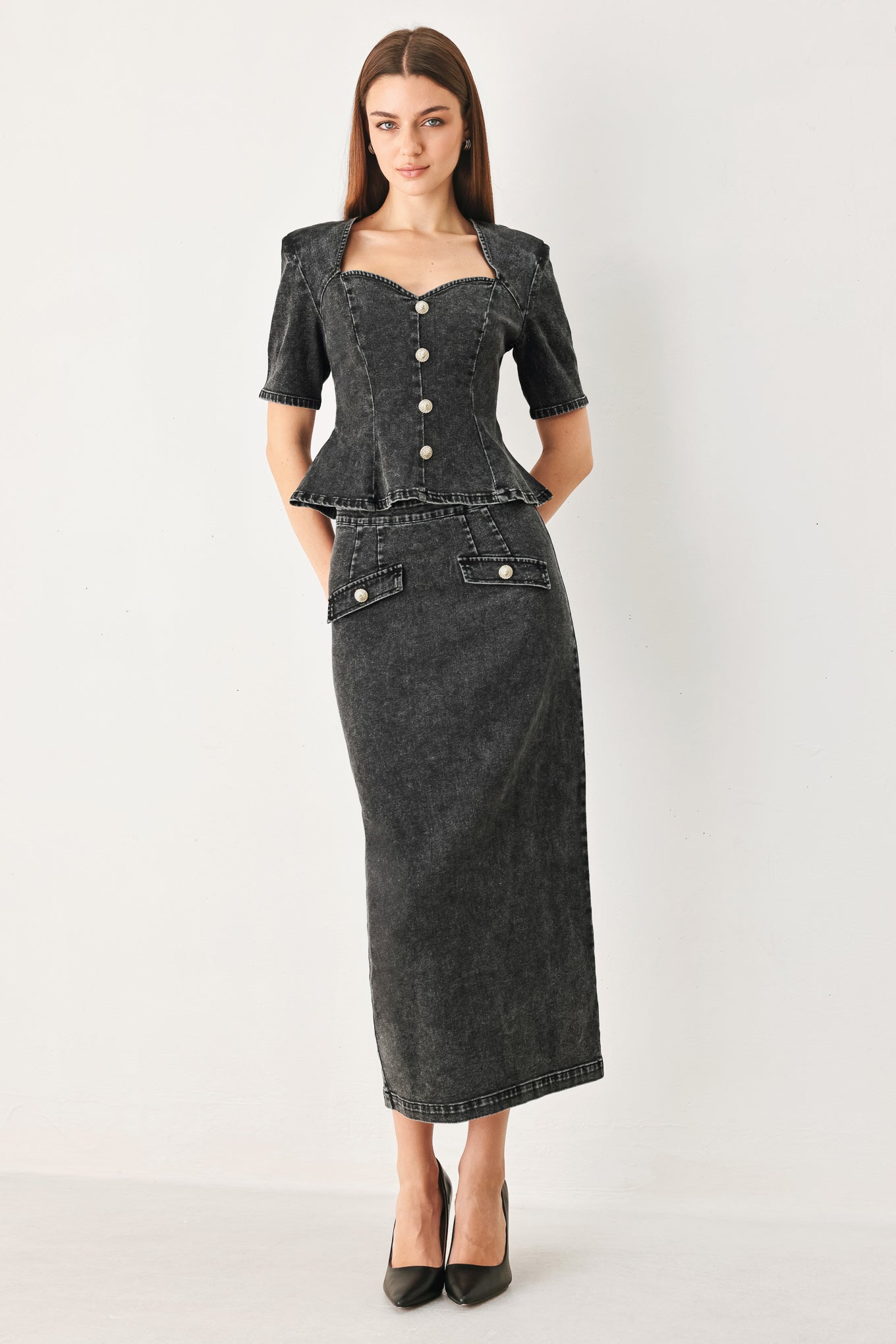Woman wearing a washed black denim midi pencil skirt with back slit and zipper closure | FREEMARKET
