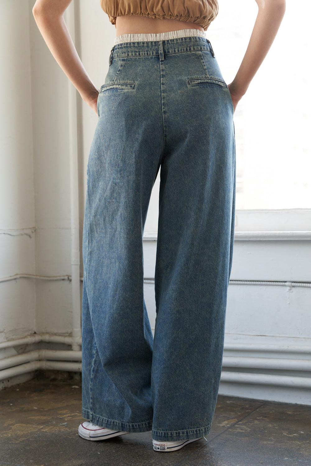 SOMEWHERE UP ABOVE DENIM PANTS.