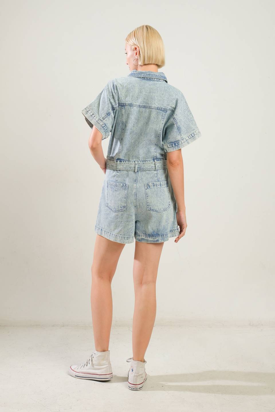 A washed denim romper featuring shirt collar, snap button down, short sleeve, self belt and side/back pockets
Details:
Self : 90% Cotton 10% Viscose
Size & Fit
- Model is 5`8" And Wearing Size Small
- Measurements Taken From Size Small
- Approx. Length: 32" Inseam: 3"
