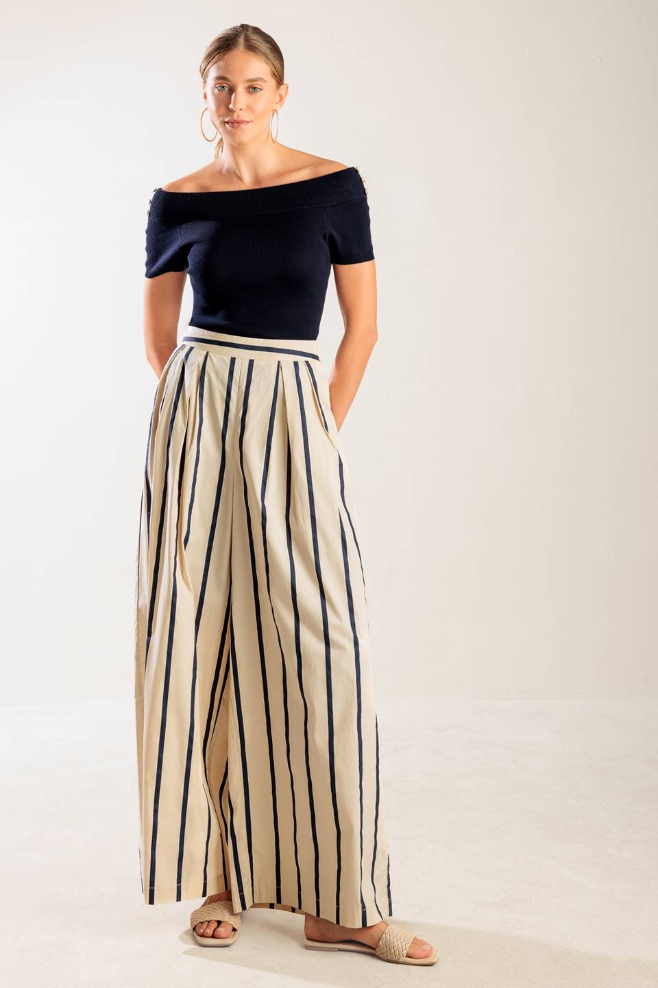 A striped woven pant featuring side zipper closure and wide leg.